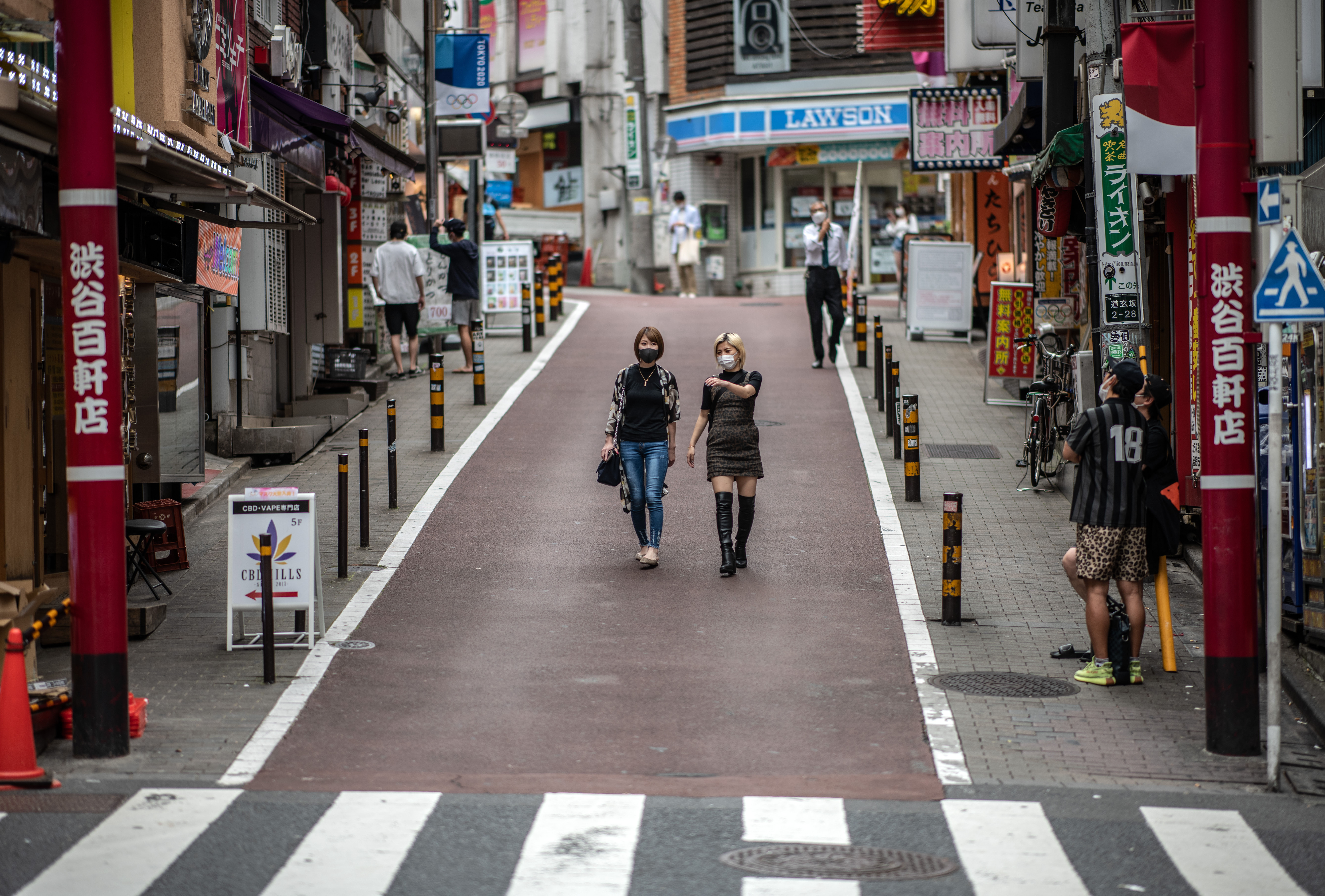 People walk through the Shibuya ward in Tokyo on May 25.