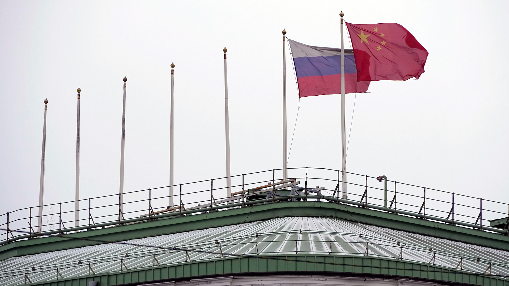 The flags of Russia and China flutter on the roof of a hotel with the flags of other countries removed in central St. Petersburg, Russia, on Wednesday, November 30, 2022. 