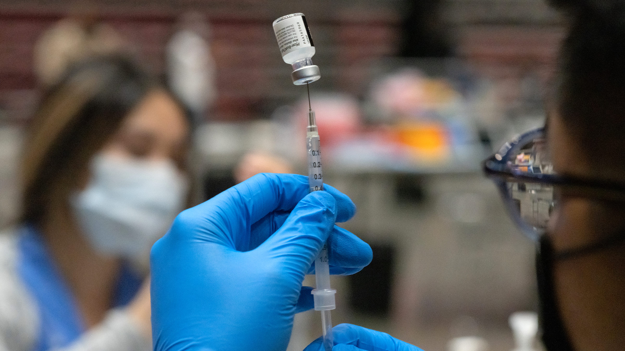 A health care worker prepares a dose of the Pfizer-BioNTech Covid-19 vaccine inside the Viejas Arena in San Diego, California, on Thursday, April 1. 