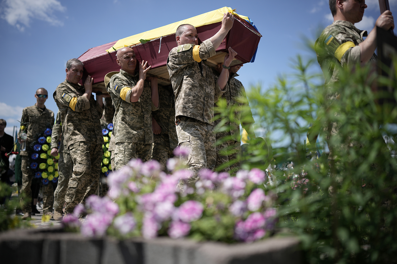 Ukrainian soldiers carry the coffin of Roman Tkachenko, aged 21 who was killed fighting the Russian invasion near Kharkiv on June 4, in Kyiv, Ukraine. 