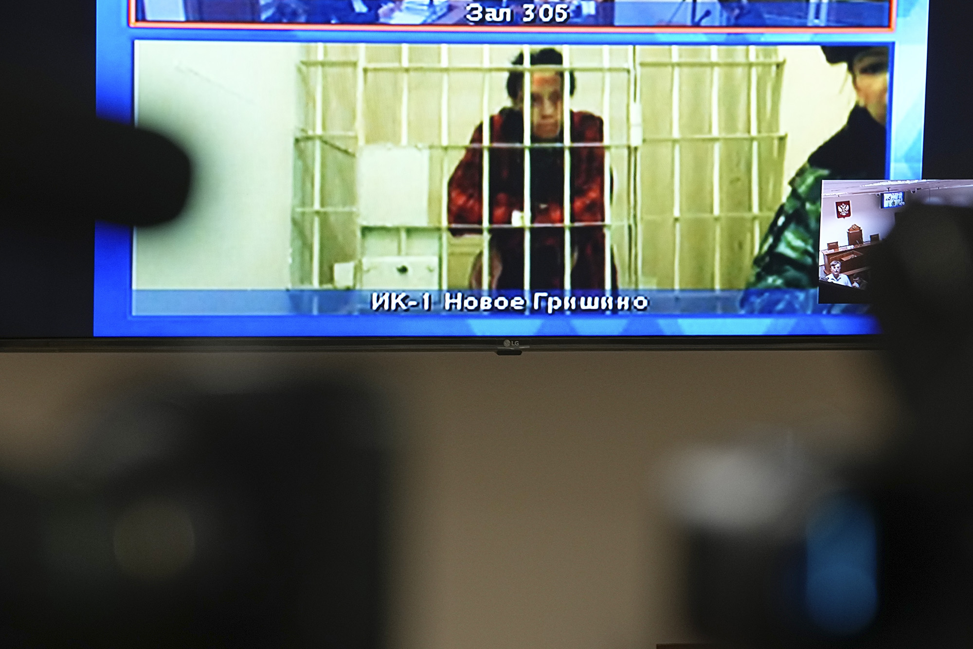 Brittney Griner is seen on the bottom part of a TV screen as she waits to appear in a video link provided by the Russian Federal Penitentiary Service prior to a hearing at the Moscow Regional Court in Moscow, Russia, on October 25.