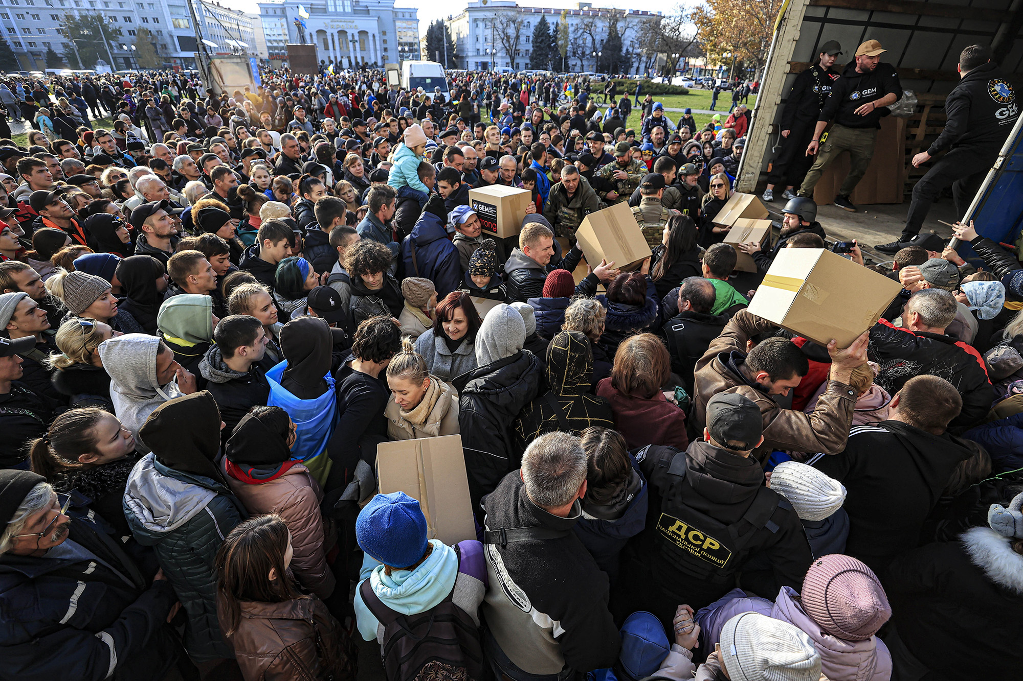 People get in line to receive humanitarian aid at Independence Square in Kherson, Ukraine, on November 15.