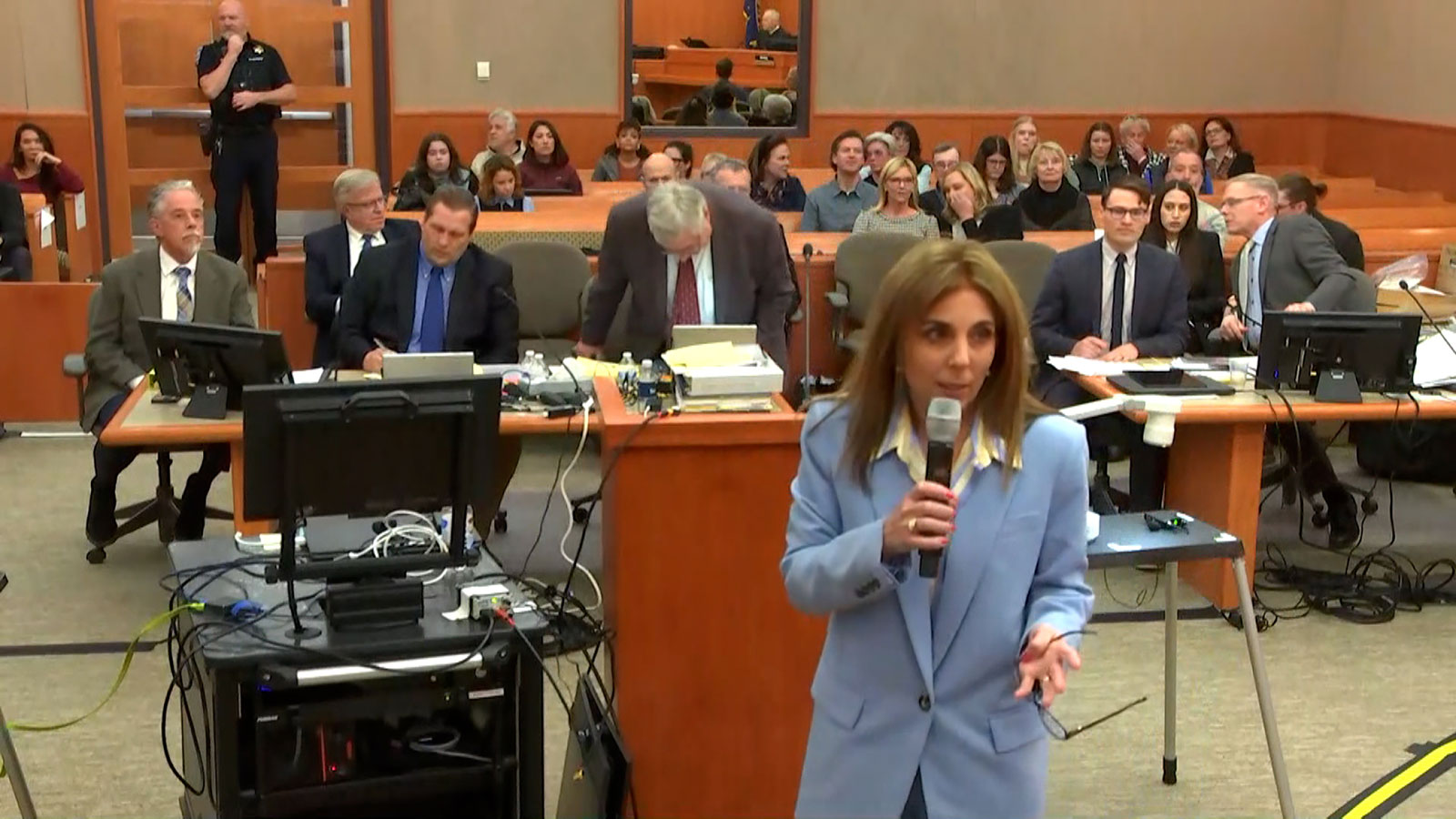 Attorney Kristin VanOrman, center, walks towards the stand to reenact the ski crash. 