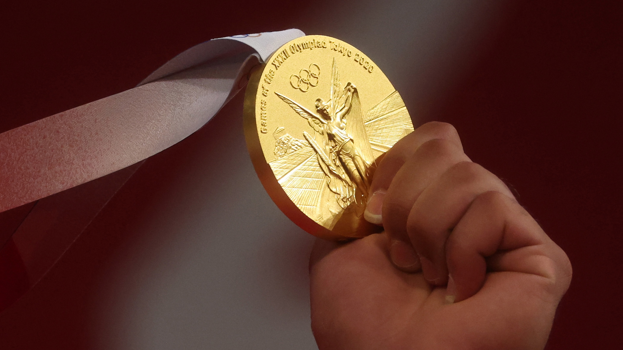 Qatar's Fares El-Bakh holds his gold medal for the weightlifting 96kg on July 31.
