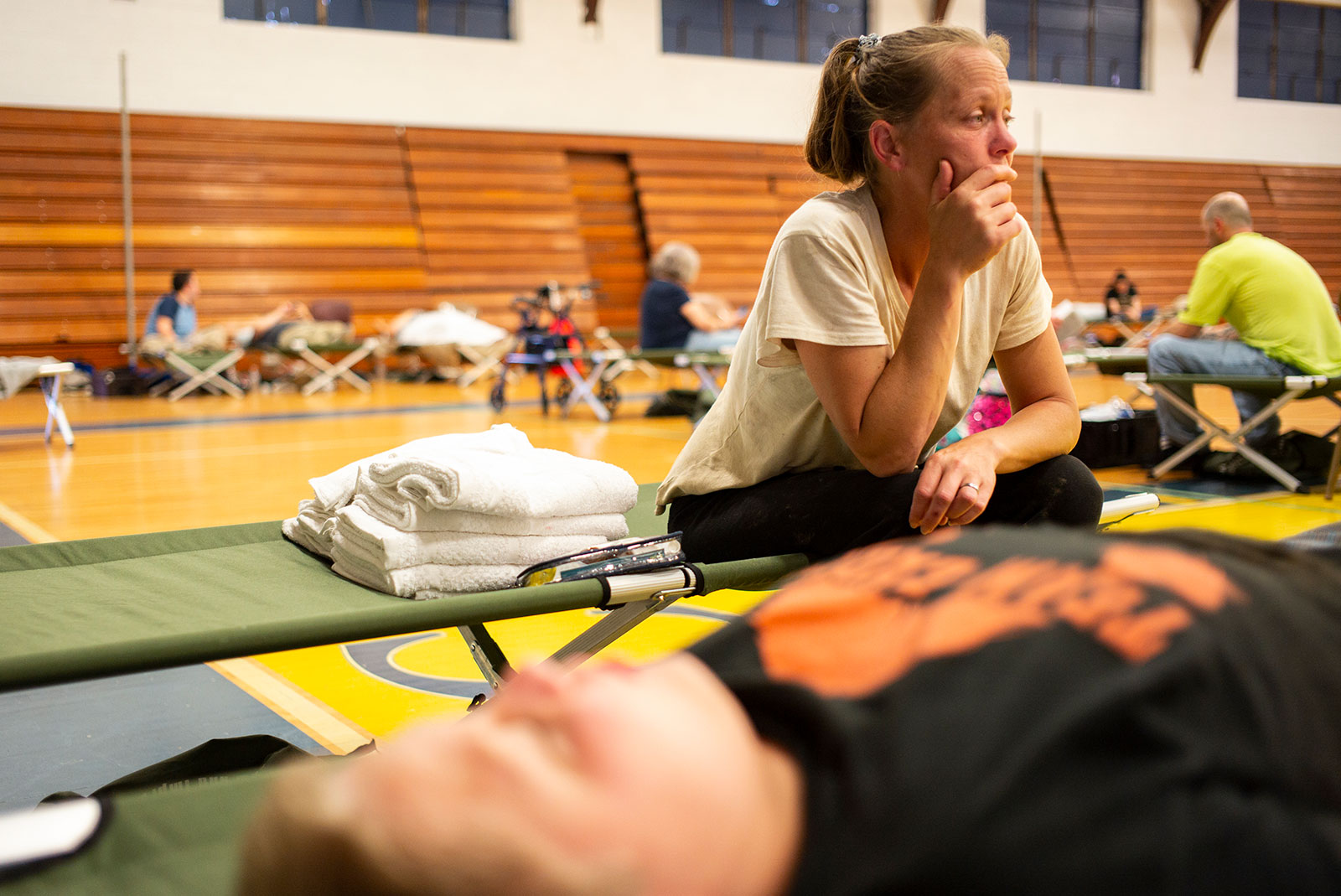 April Stivers, 38, of Lost Creek, Kentucky, takes a moment to herself at Hazard Community & Technical College on July 28, where people displaced by flooding are being taken for shelter.