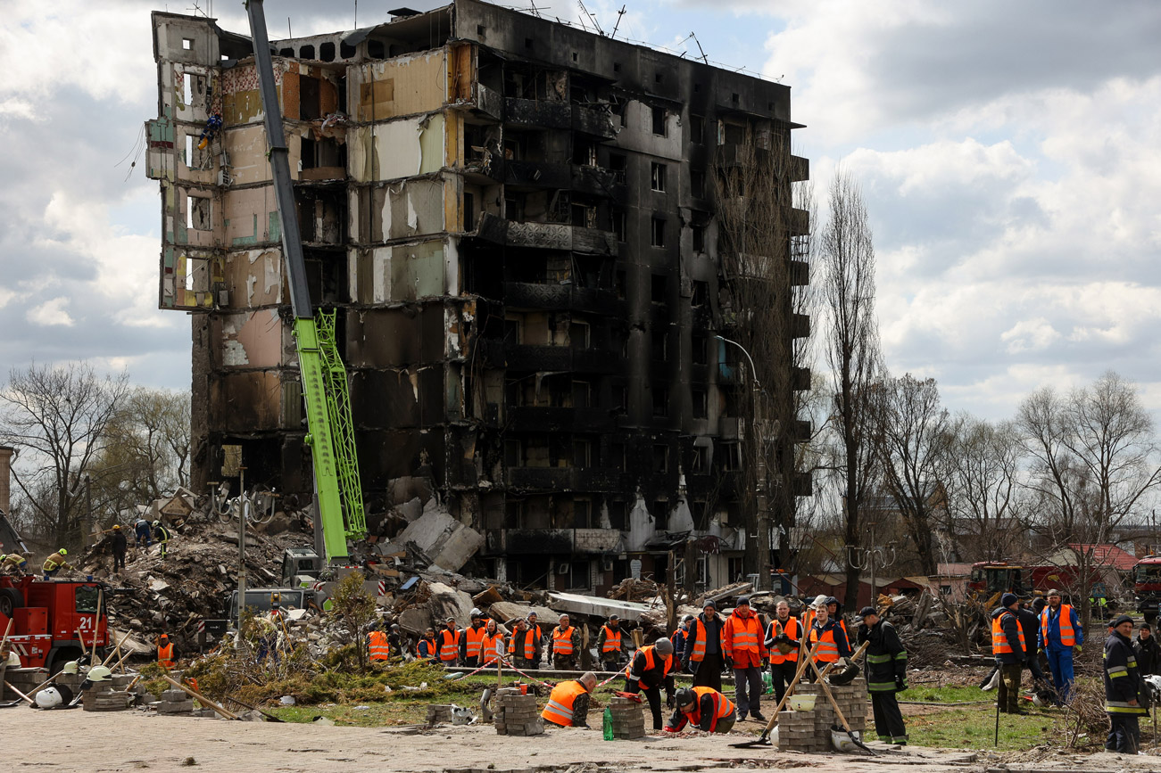 周一，救援人员在基辅地区博罗季安卡的一座被俄罗斯炮击摧毁的建筑物的废墟下寻找尸体。