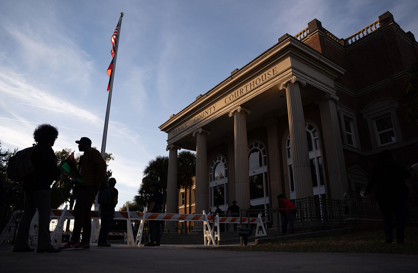 People stand outside the Gylnn County Courthouse on November 23.