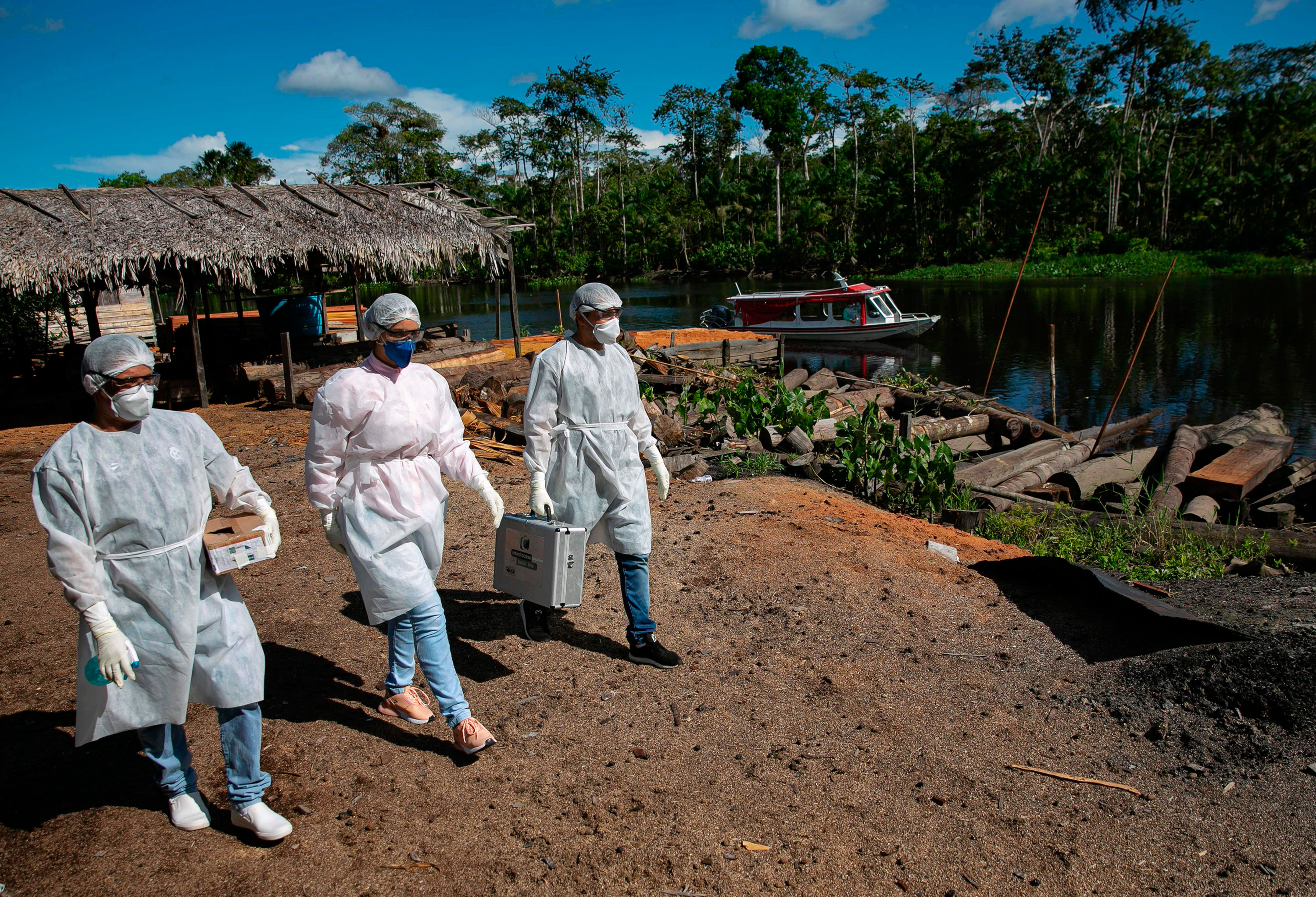 Government health workers visit riverside communities to conduct coronavirus tests on May 23 in Para, Brazil.