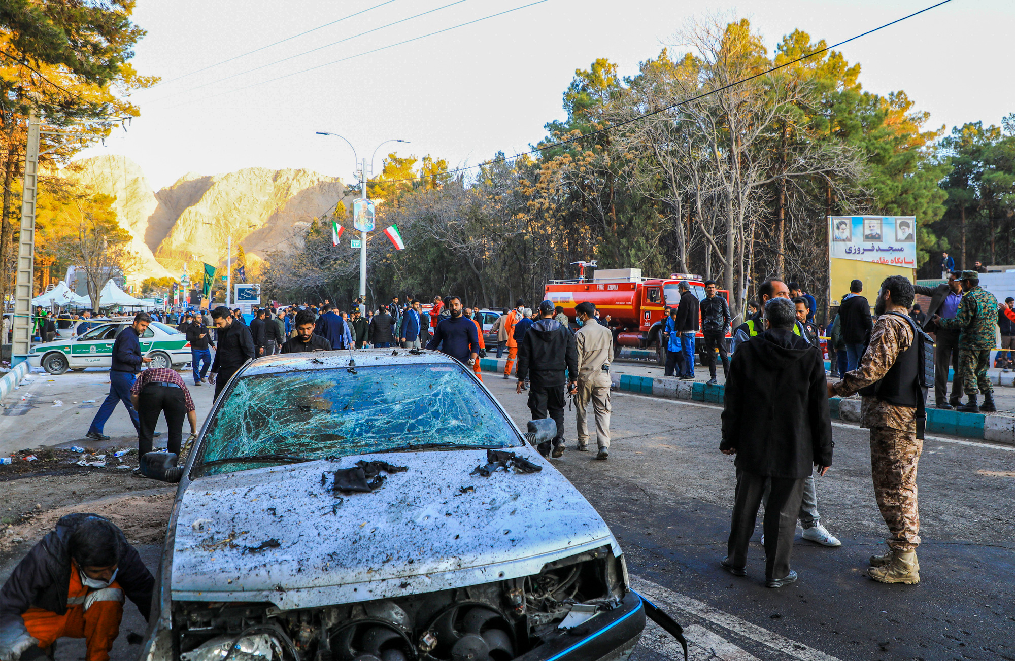 Civilians and emergency personnel gather at the site of twin blasts in Kerman, southern Iran on January 3.