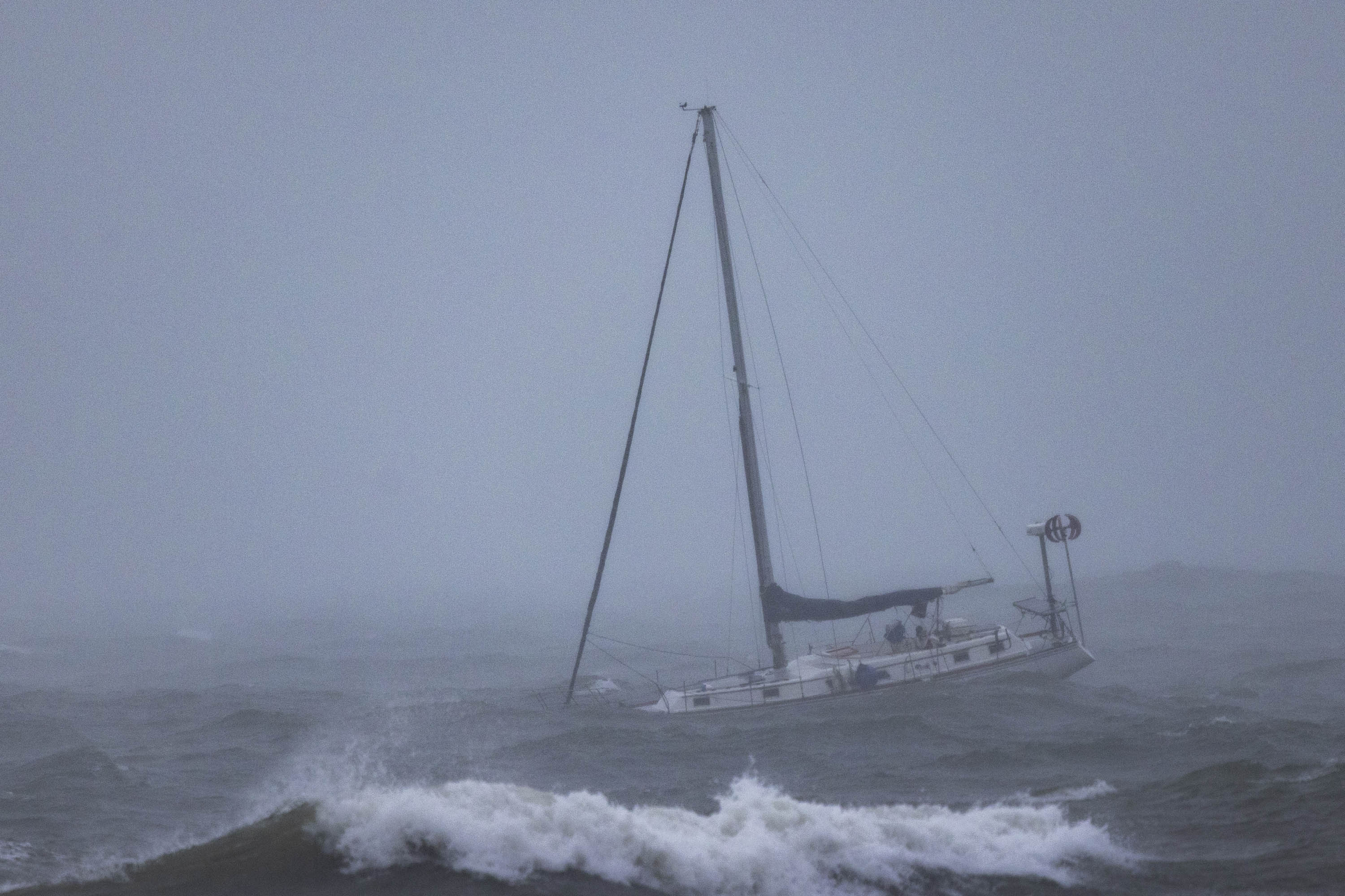 A boat moored offshore is tossed by rough waters in Santa Barbara.