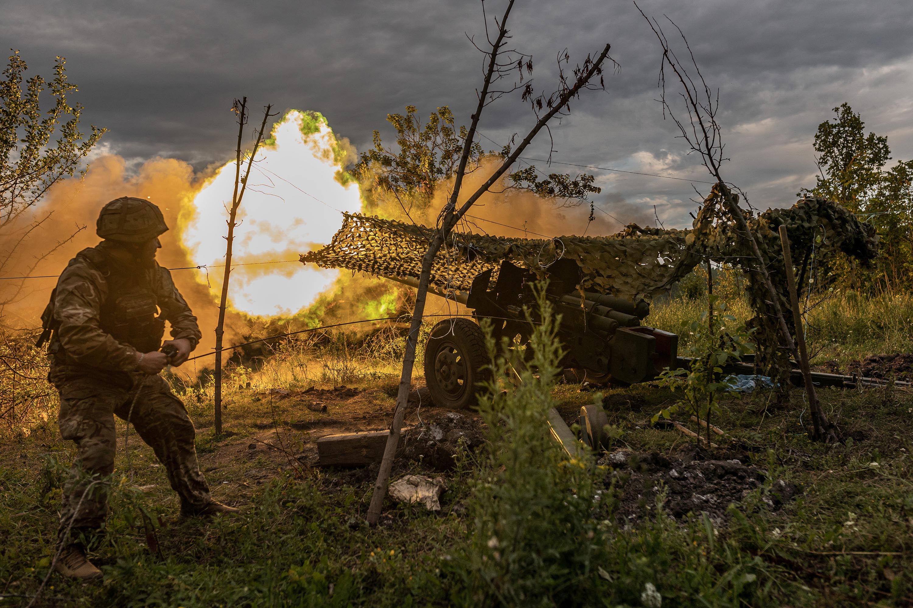 A Ukrainian soldier fires artillery in the direction of Bakhmut, Ukraine, on July 22.