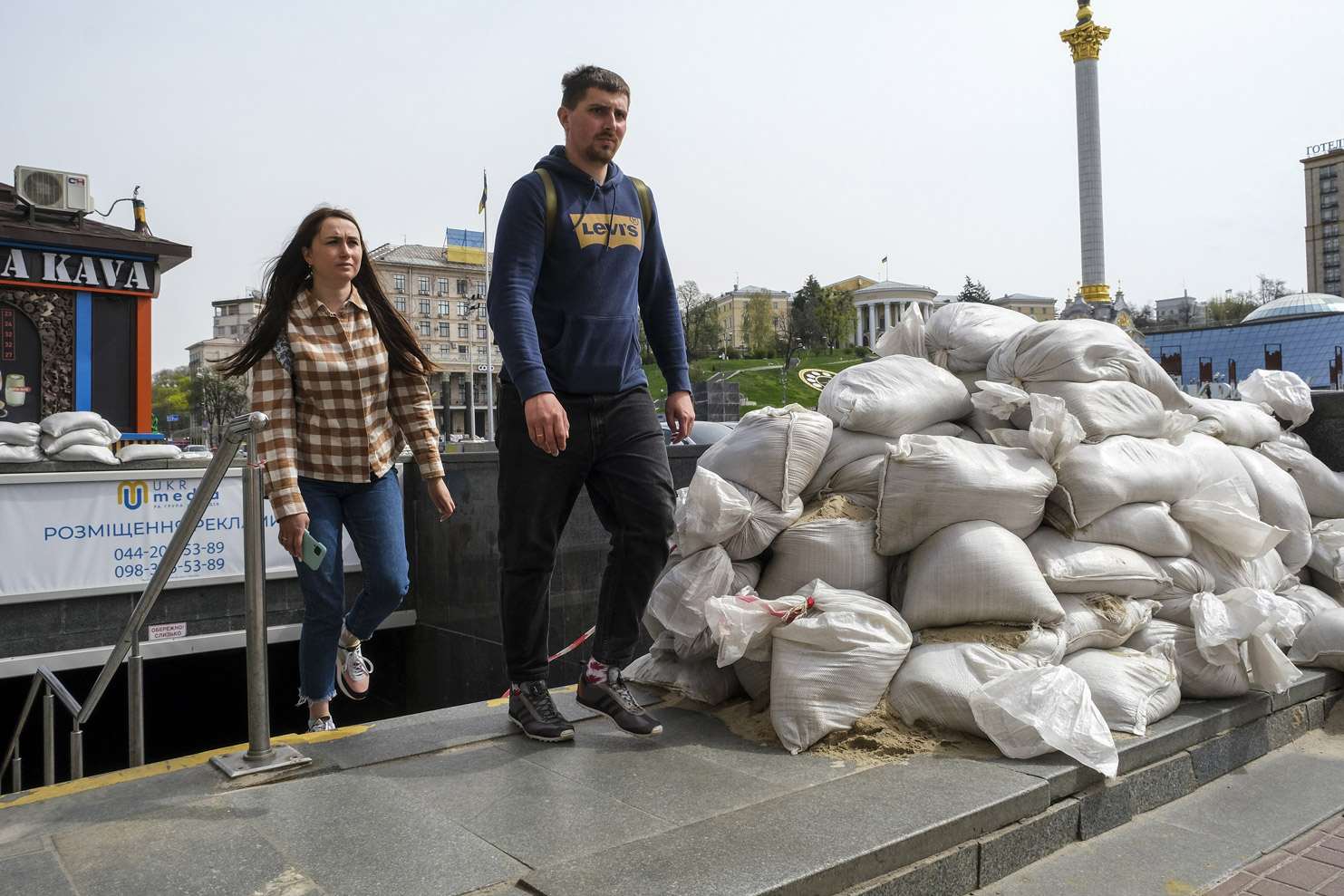 Kyiv residents walk around the city on Monday.