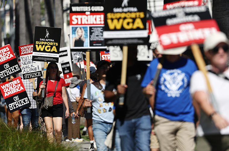 A sign reads 'SAG-AFTRA Supports WGA' as SAG-AFTRA members walk the picket line in solidarity with striking WGA (Writers Guild of America) workers outside Netflix offices on July 13, 2023 in Los Angeles, California. 