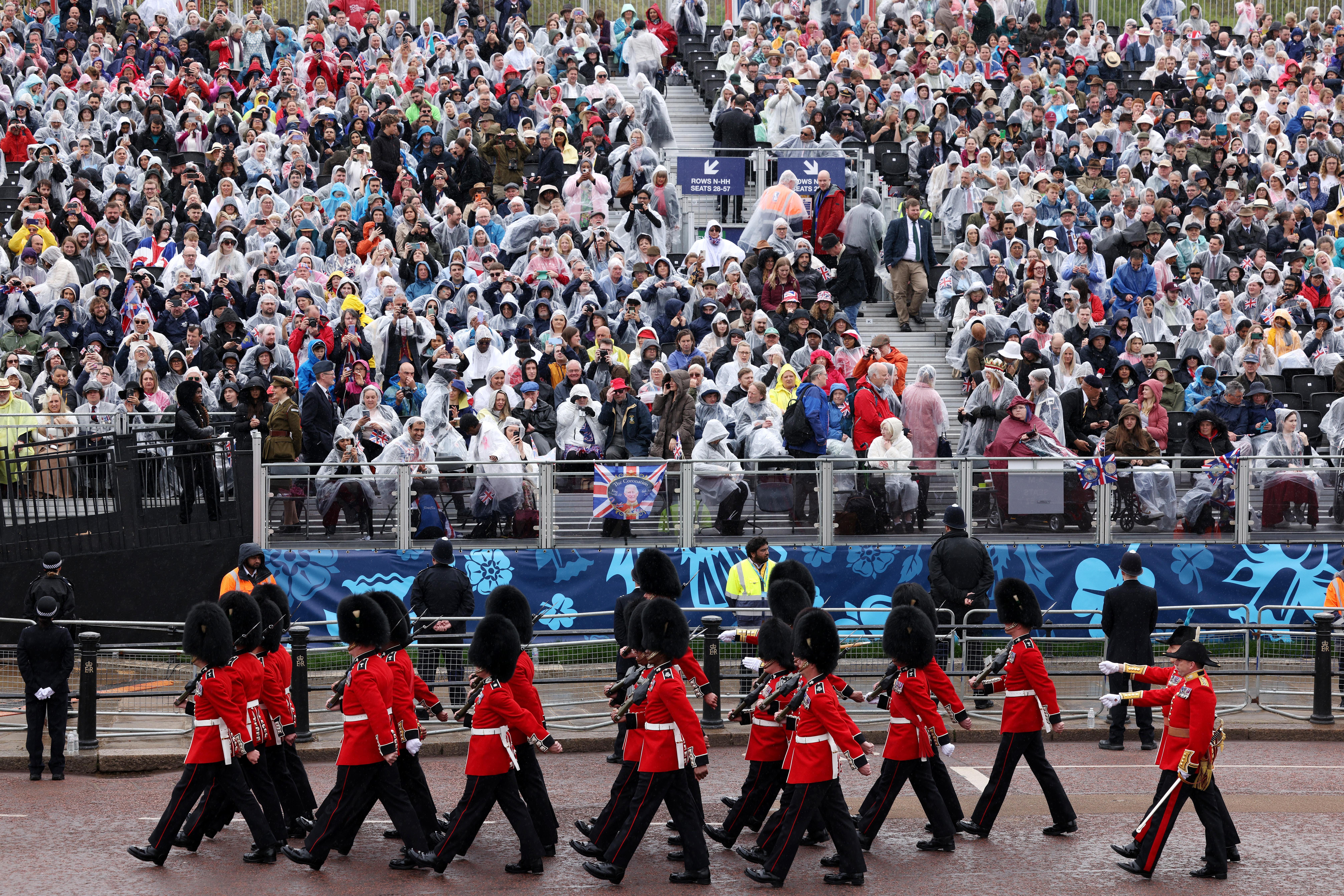 Coldstream Guards march past the rain-soaked crowd ahead of the coronation of King Charles III and Queen Camilla in London on Saturday. 