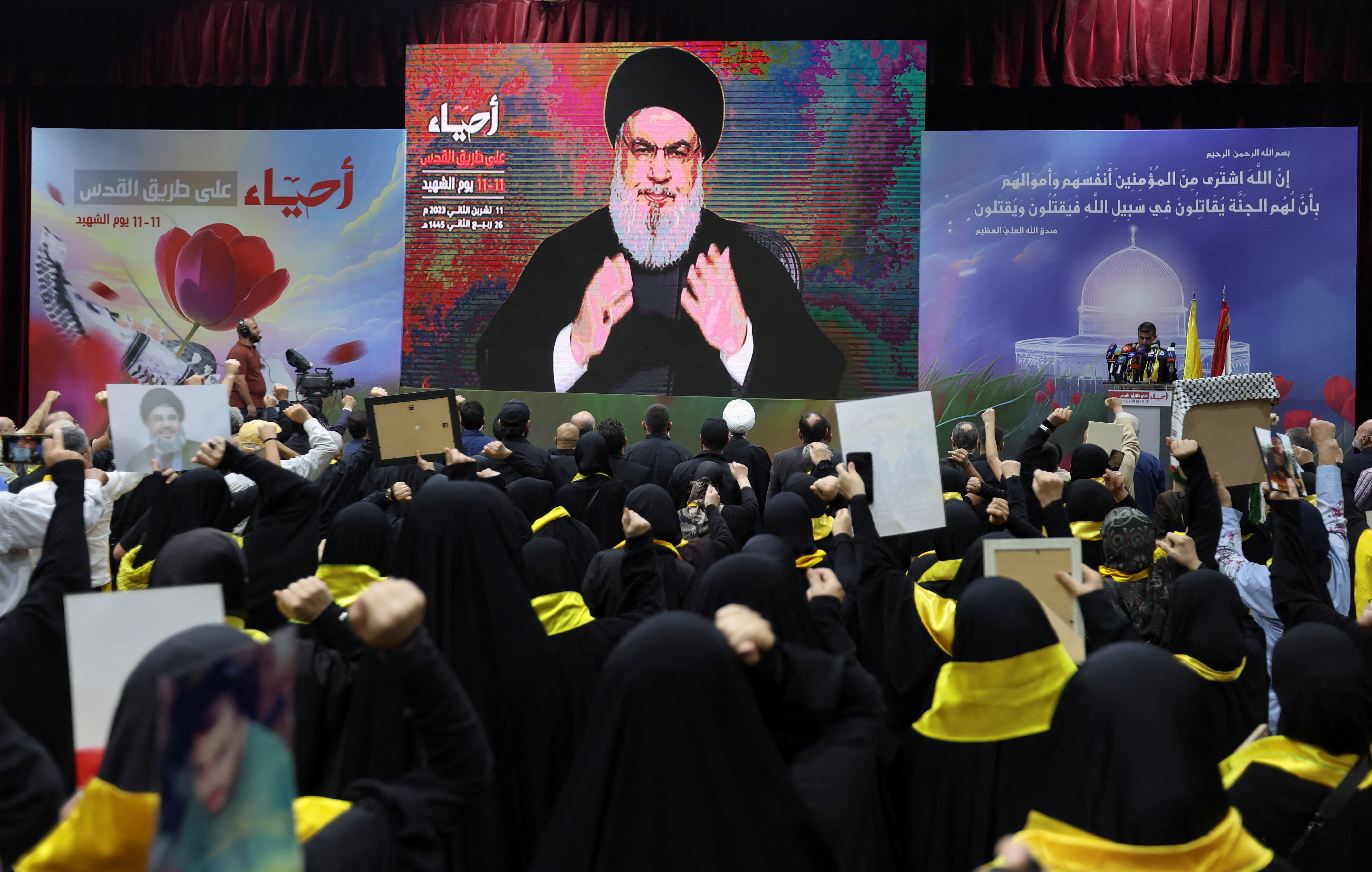 Supporters watch Hezbollah Secretary General Hassan Nasrallah deliver an address in Lebanon on November 11. 