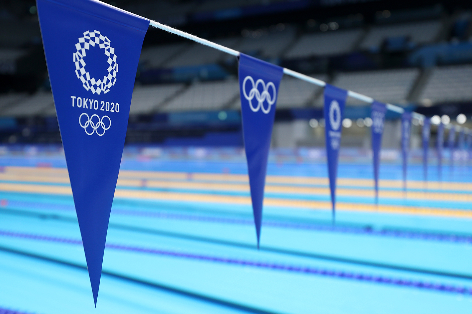 Flags hang over the pool during aquatics training at the Tokyo Aquatics Centre ahead of the Tokyo 2020 Olympic Games on July 22, in Tokyo, Japan. 