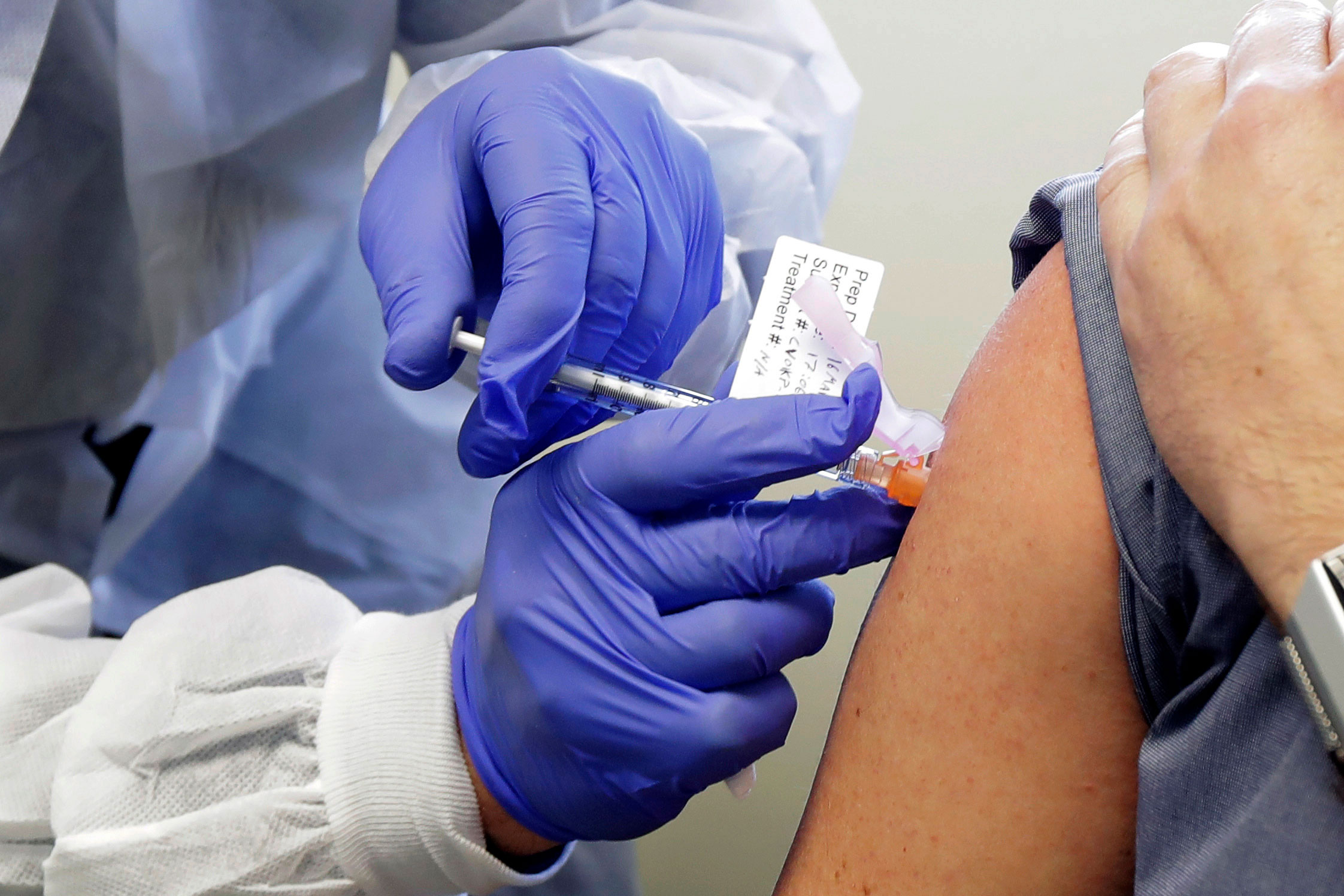 A subject receives a shot in March, during the first-stage clinical trial of a potential coronavirus vaccine.