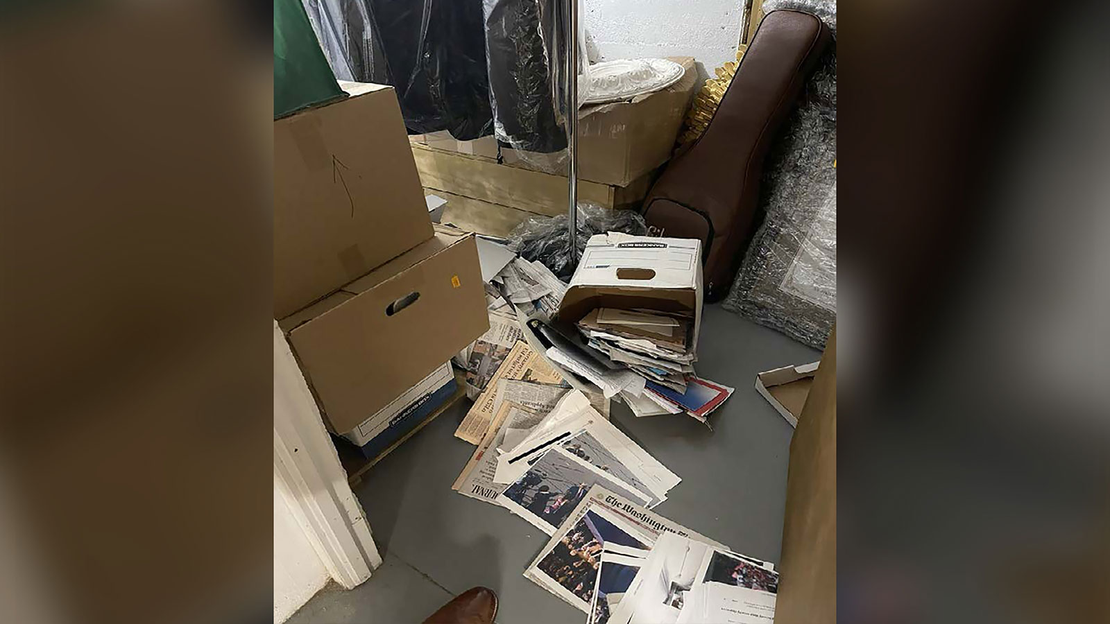 Fallen boxes spill documents onto the floor in this photo included in Donald Trump’s federal indictment.