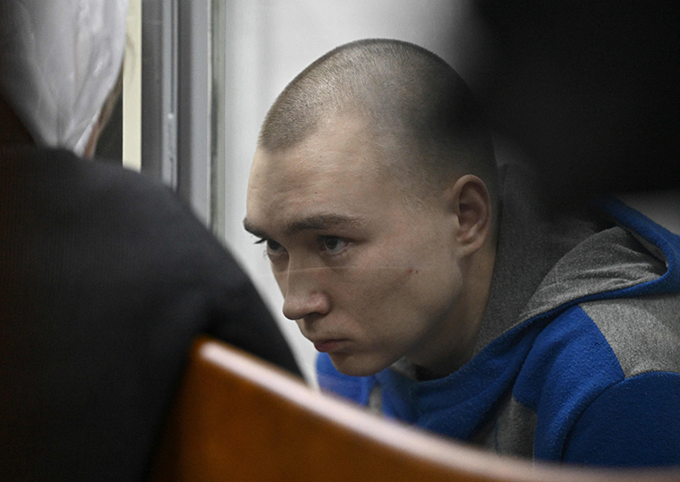 Russian soldier Vadim Shishimarin sits in the defendant's box at the opening of his trial in the Solomyansky district court in Kyiv on May 18.