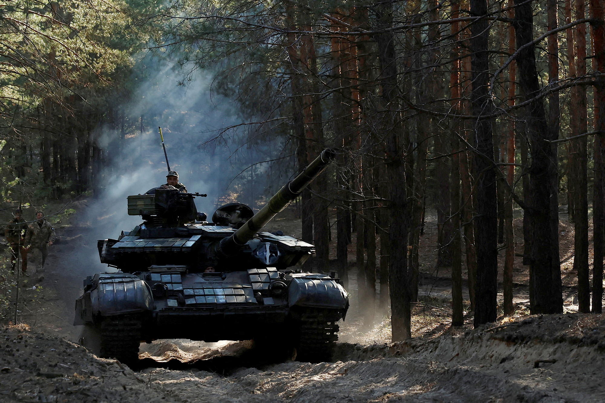 Ukrainian soldiers drive a captured Russian tank in the Kupiansk region of Kharkiv Oblast, Ukraine, on October 15.