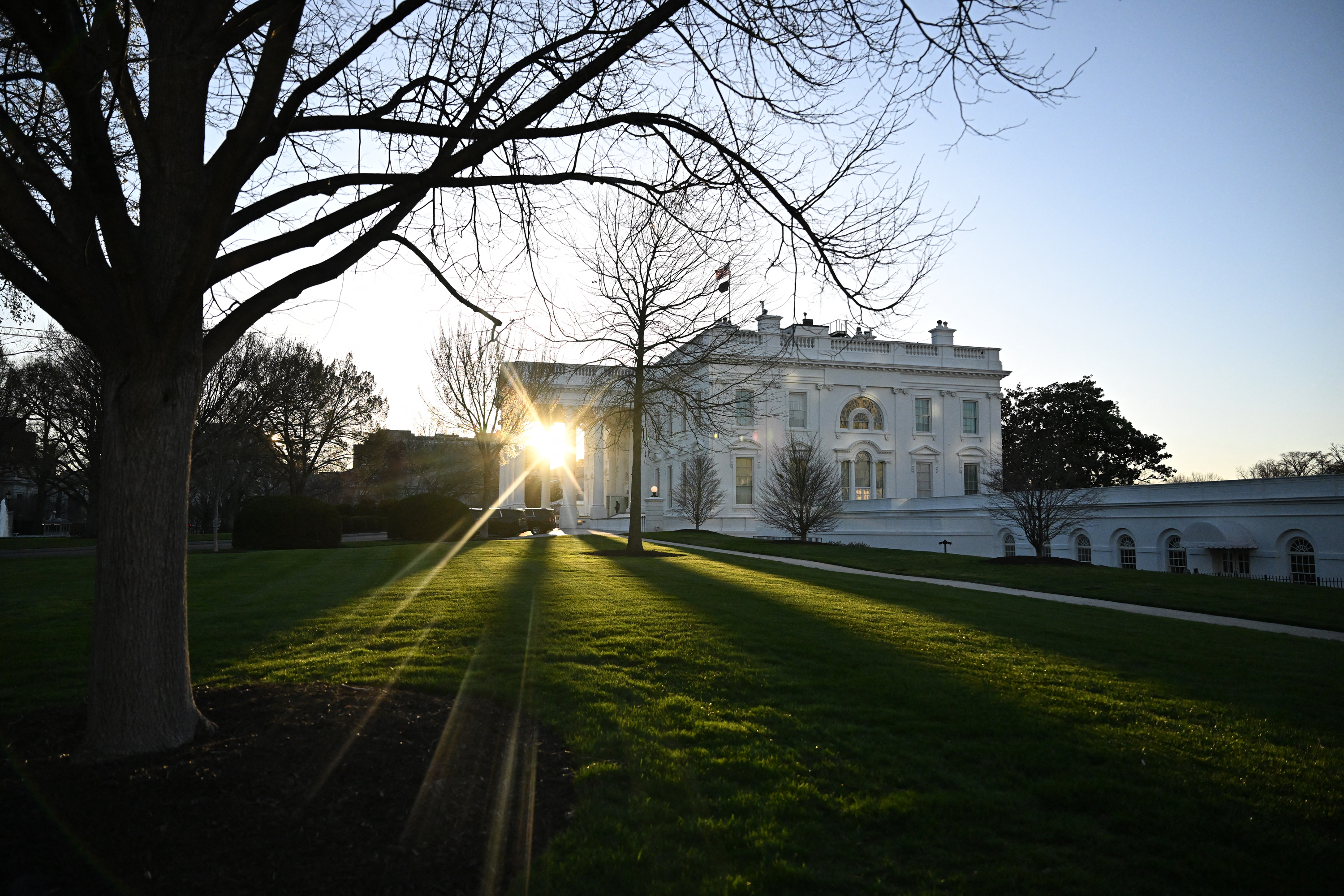 The sun rises through the North Portico of the White House in Washington, DC, on March 11.