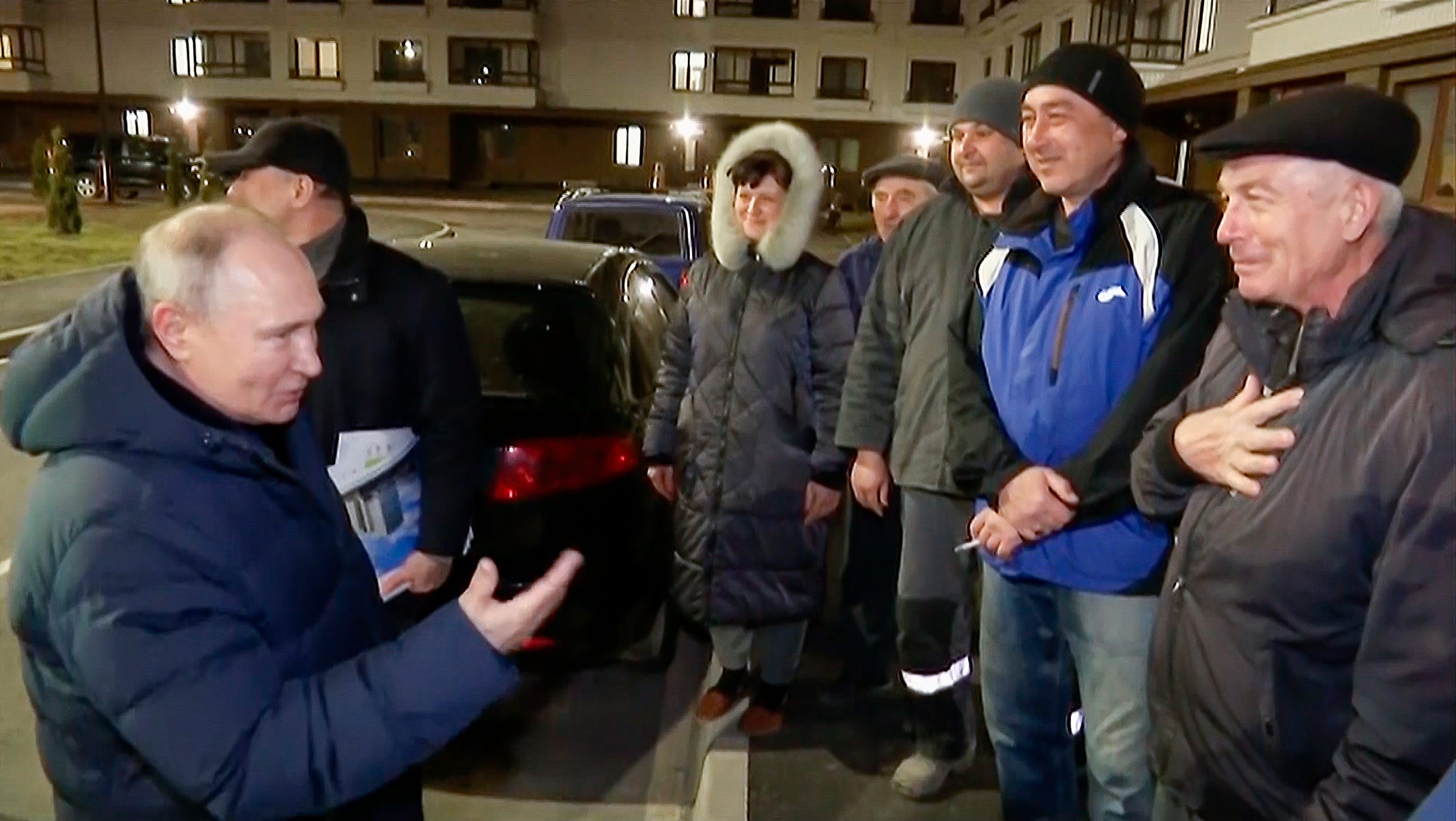 Russian President Vladimir Putin talks with local residents during his visit to Mariupol, Ukraine, in a video released on March 19. 