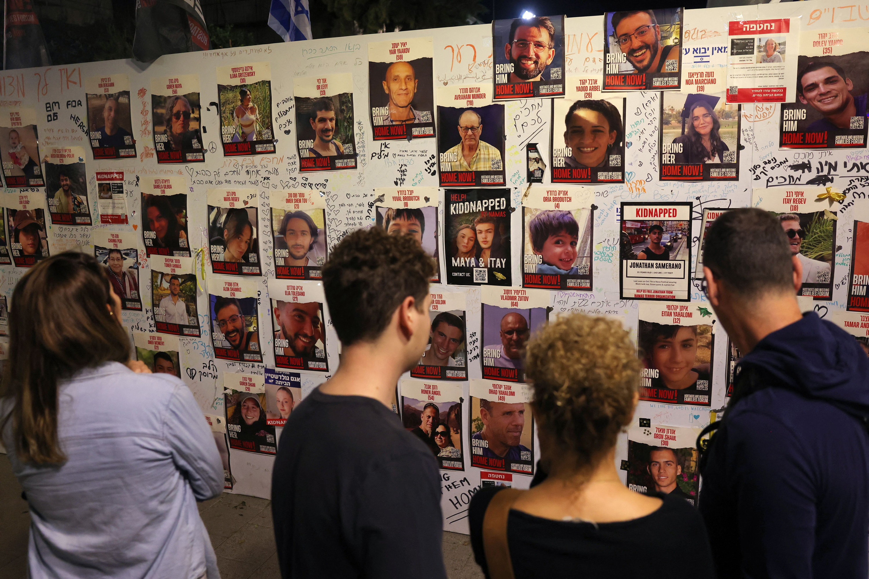 People look at pictures of Israeli hostages in Tel Aviv, on November 11.