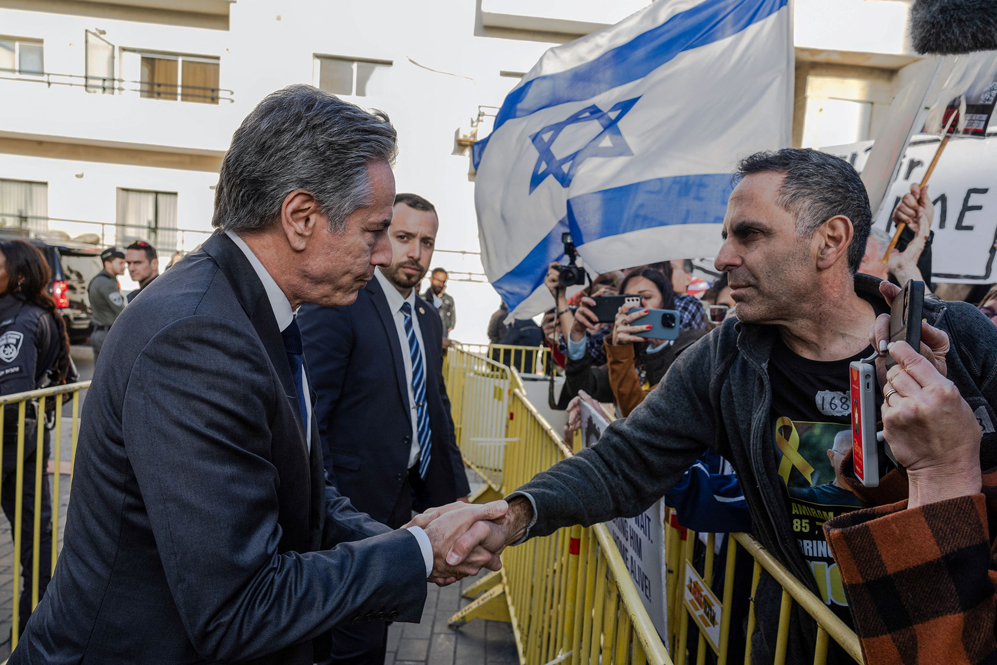 U.S. Secretary of State Antony Blinken shakes hands with a man as he meets demonstrators calling for the release of hostages kidnapped in the October 7 attack, outside the Kempinski hotel in Tel Aviv, Israel, on March 22.