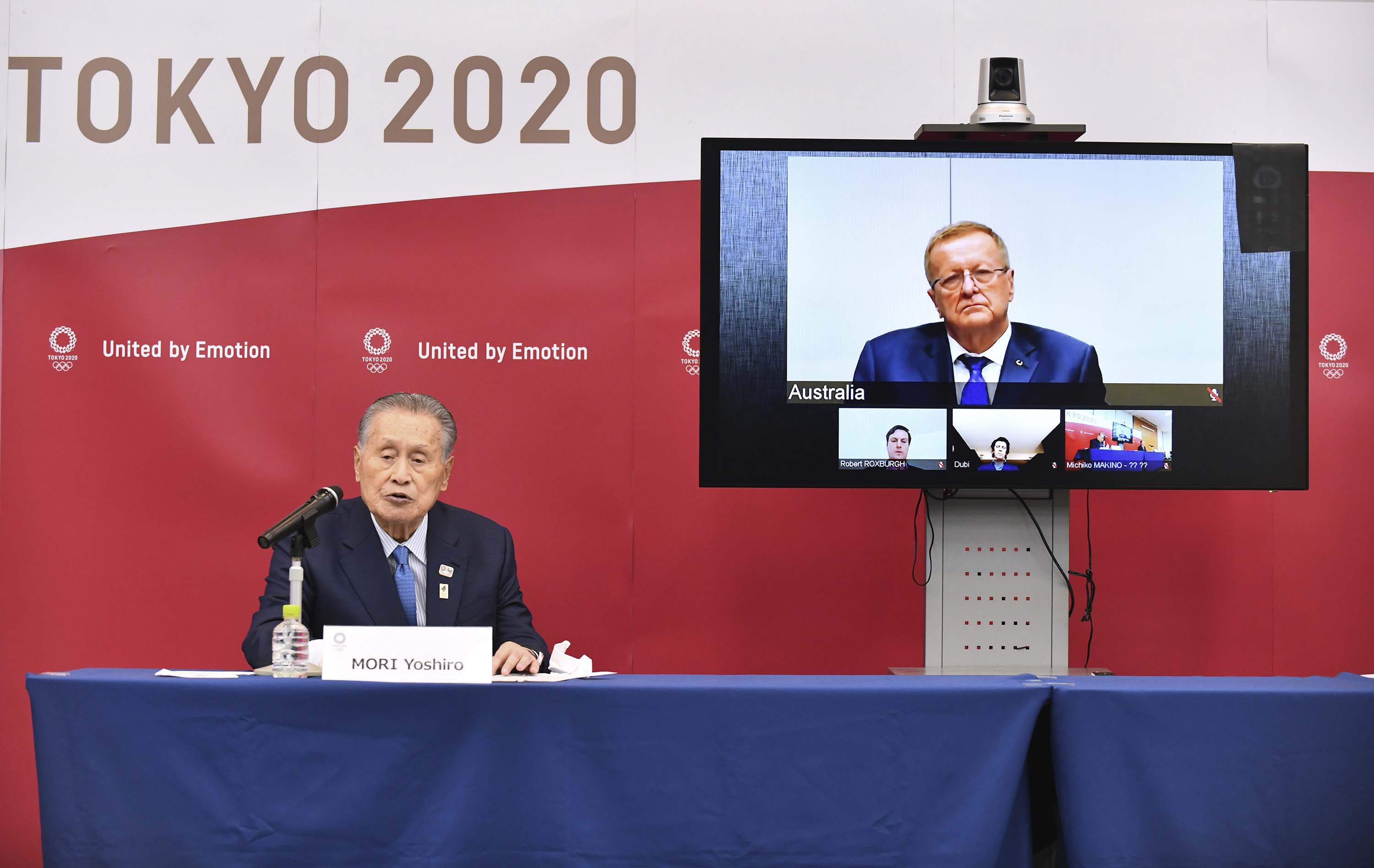 Tokyo 2020 Organizing Committee President Yoshiro Mori, left, speaks in teleconference with John Coates, chairman of the IOC's Coordination Commission for the Tokyo 2020 Olympic Games, in Tokyo on April 16.