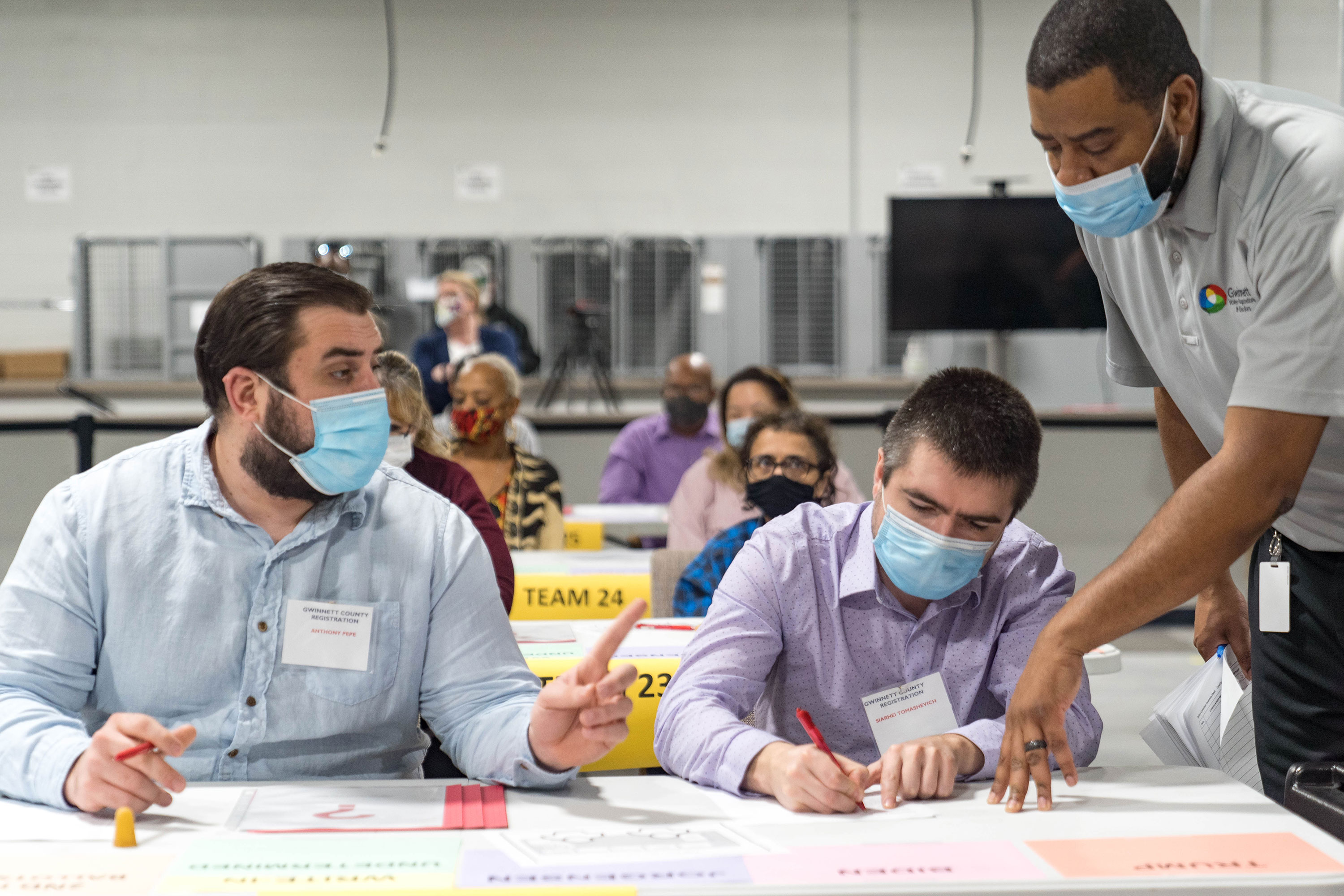 People recount ballots in Lawrenceville, Georgia, on November 13.