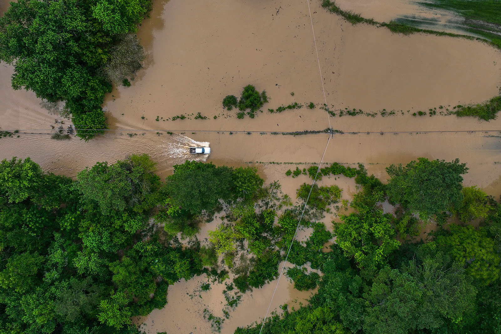 A truck drives along flooded Wolverine Road in Breathitt County, Kentucky, on Thursday, July 28.