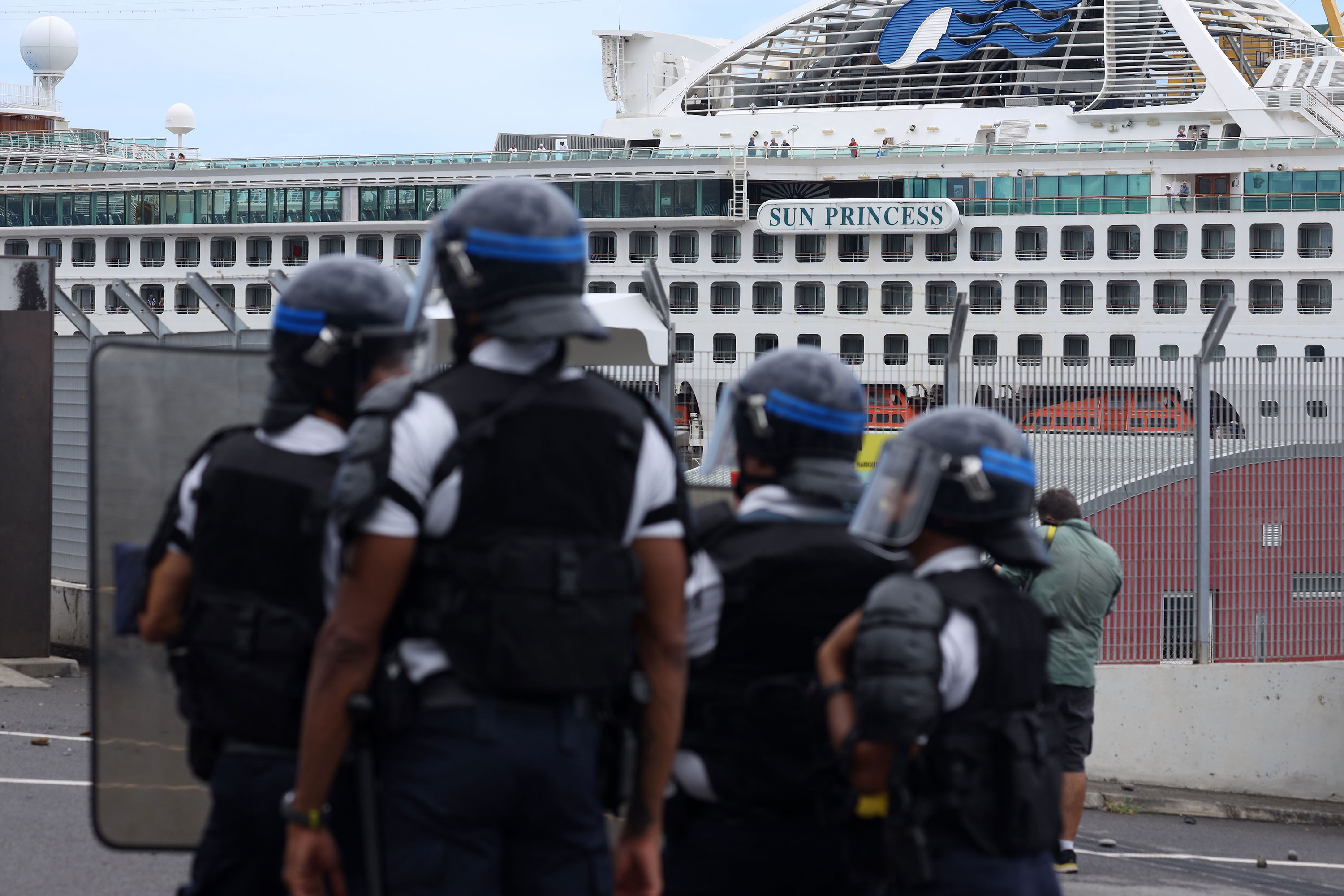 French police officers face demonstrators in Le Port on the Indian Ocean island of La Reunion on March 1.