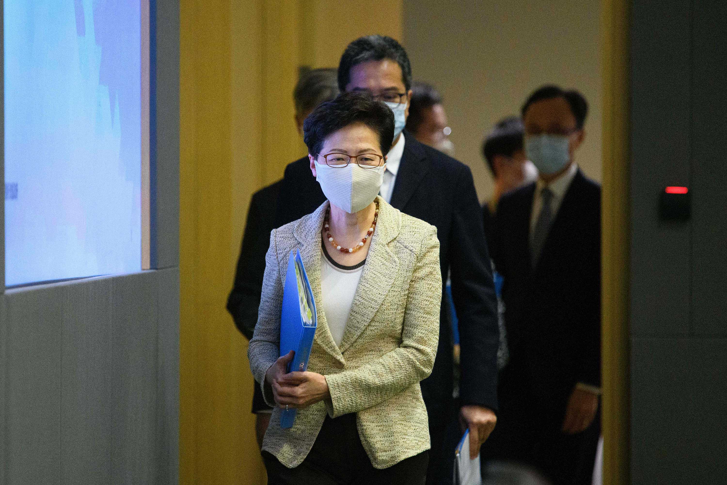 Hong Kong Chief Executive Carrie Lam and other government officials arrive for a press conference at government HQ on August 21, to provide details on the citywide testing initiative.