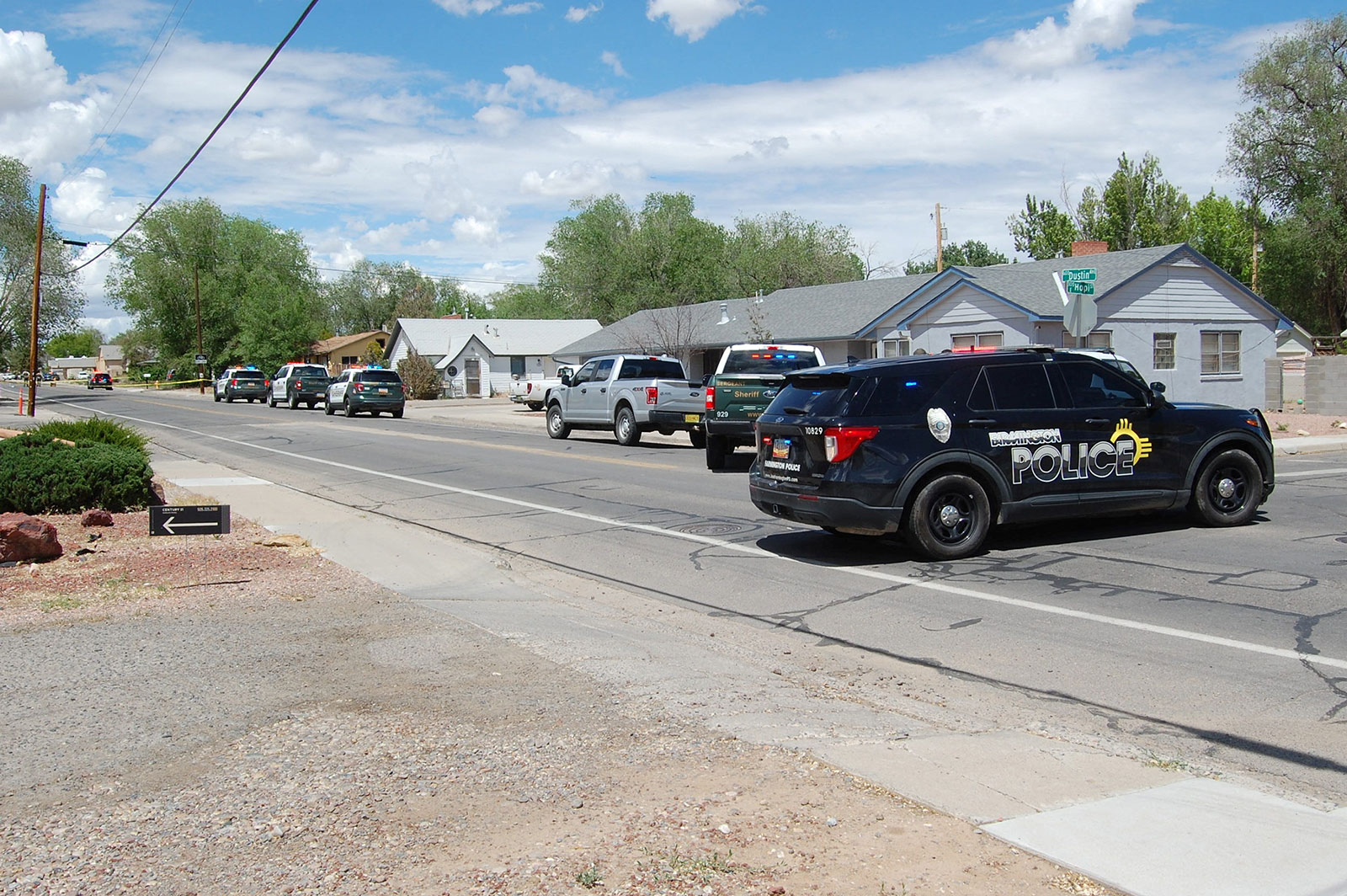 Law enforcement officers from the Farmington Police Department, San Juan County Sheriff's Office and New Mexico State Police deploy at the scene of a fatal shooting in Farmington, New Mexico, on May 15.