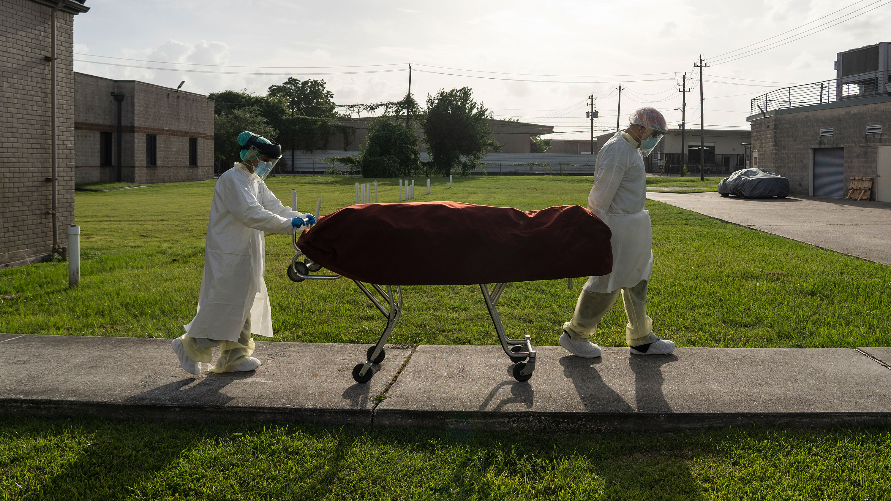 Medical staff push a stretcher with a deceased patient outside the Covid-19 intensive care unit at the United Memorial Medical Center on June 30 in Houston, Texas.