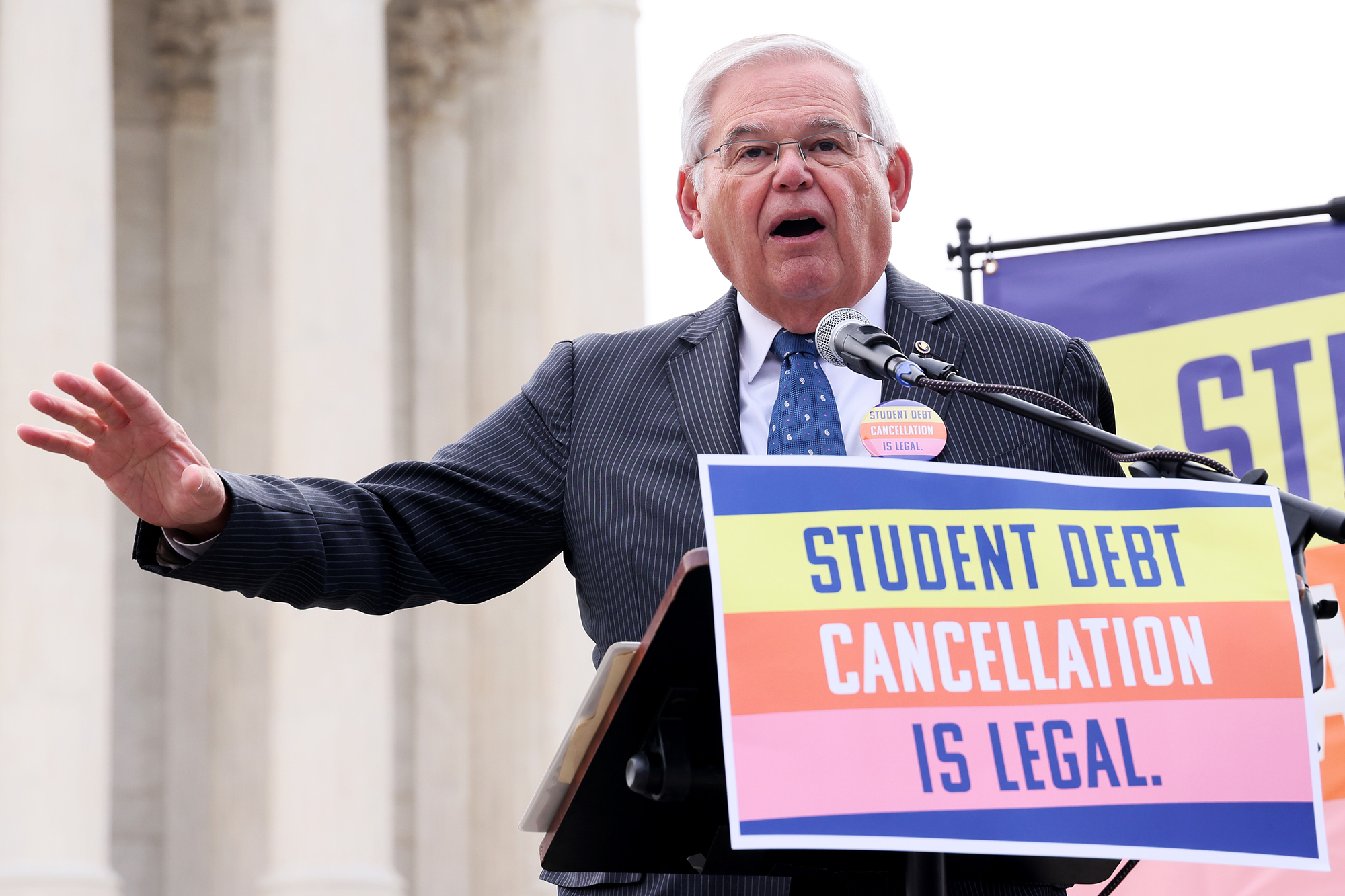 Sen. Bob Menendez speaks people gather at the Supreme Court ahead of a hearing on President Joe Biden's student debt relief plan on Tuesday.