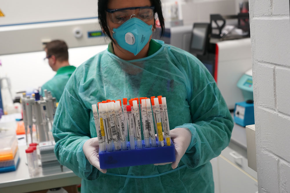 A technician holds a tray of patient swabs during the testing process for possible coronavirus infection at the IFLb medical lab on March 30 in Berlin, Germany. 