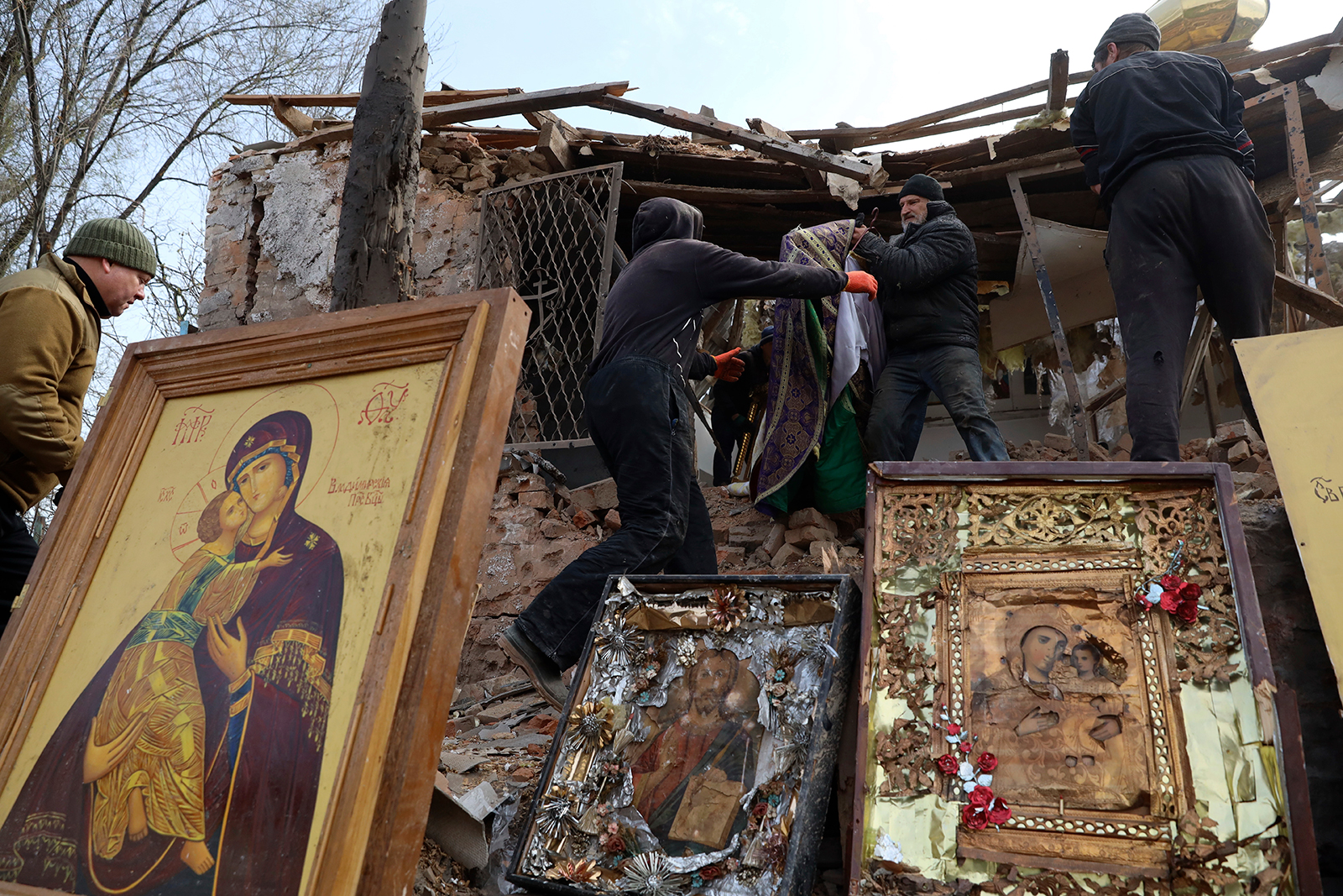 People salvage icons after an Orthodox Church in Komyshuvakha, Ukraine, was hit by a rocket. 