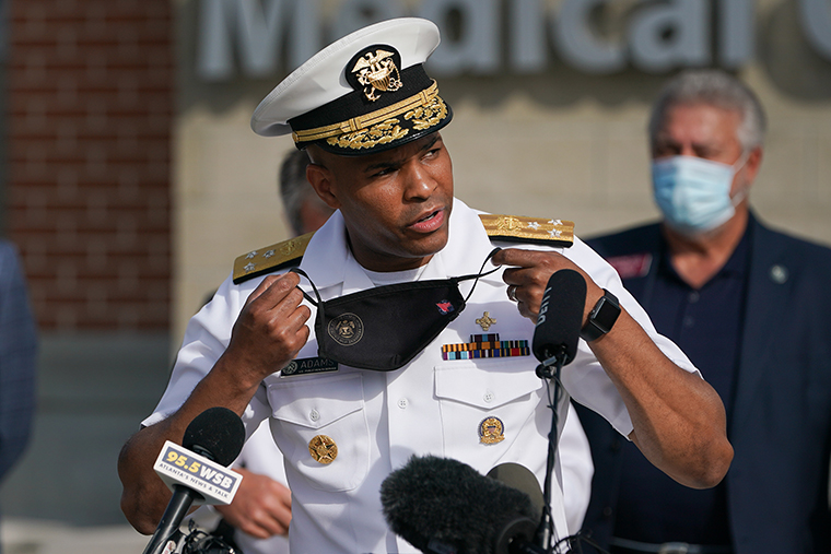 Vice Admiral Jerome Adams, U.S. Surgeon General, takes off a protective mask while speaking during a 'Wear A Mask' tour stop in Dalton, Georgia, on Thursday, July 2. 