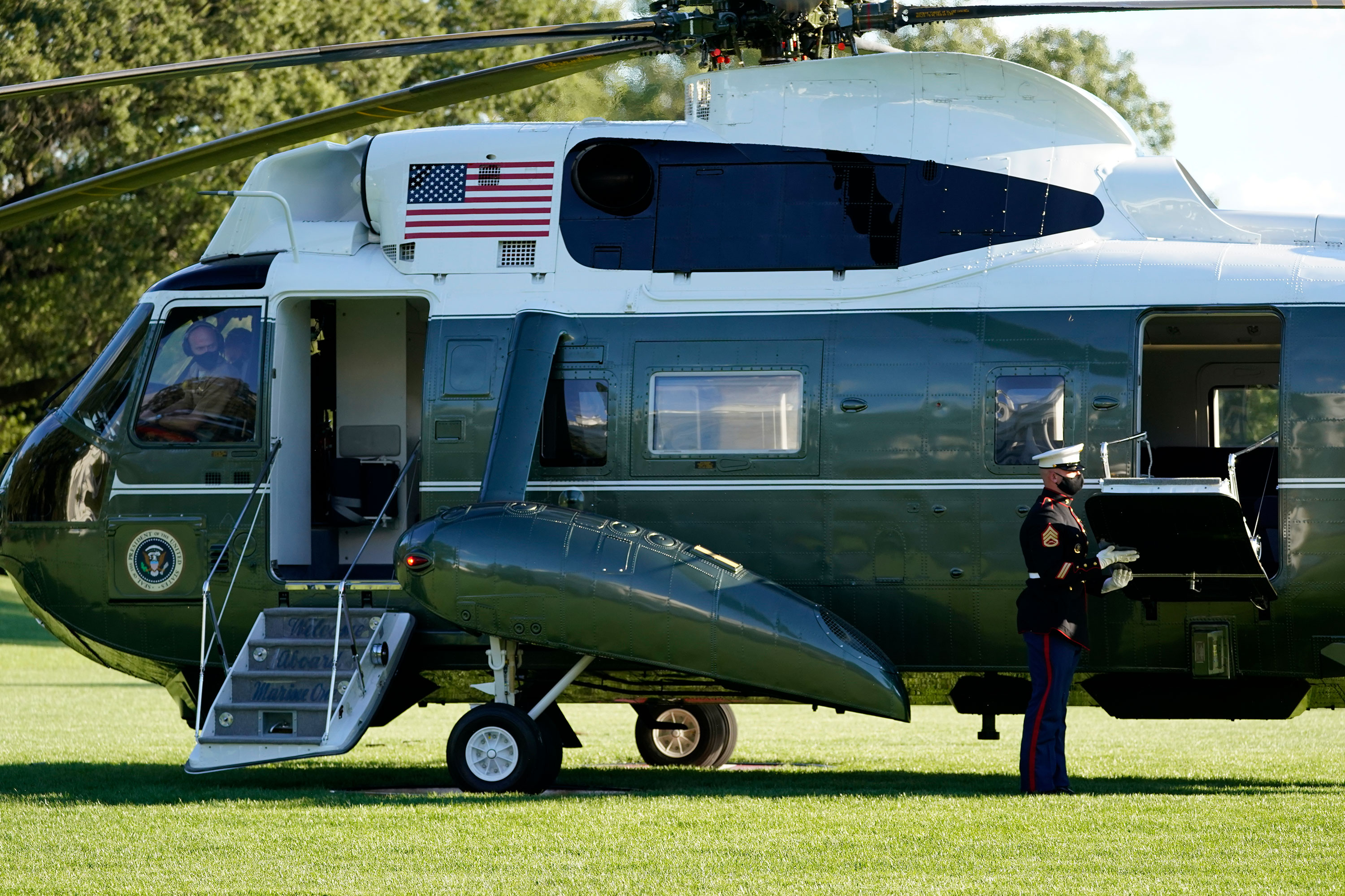 The pilot of Marine One wears a face mask as President Donald Trump prepares to leave the White House to go to Walter Reed National Military Medical Center on October 2 in Washington, DC.