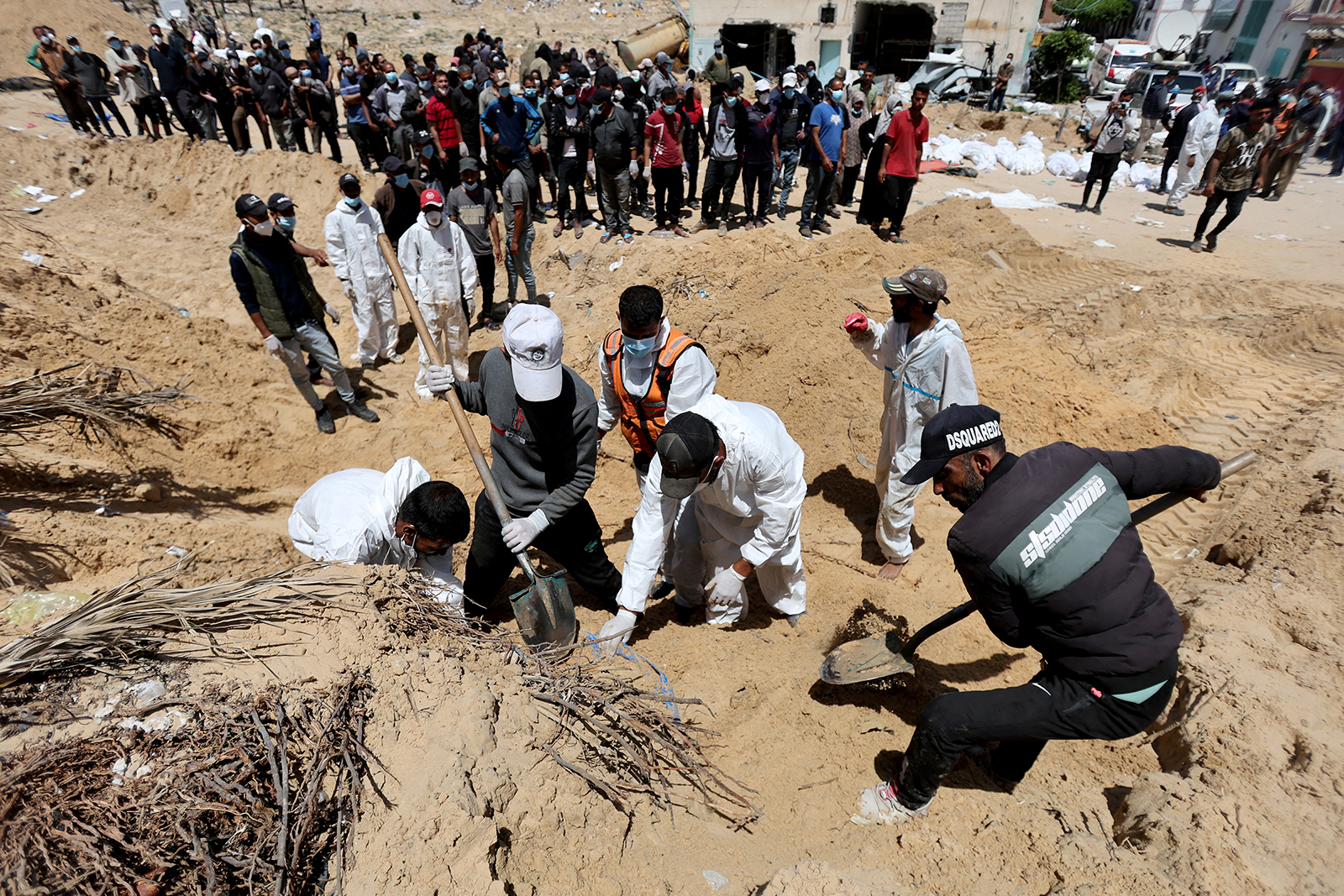 People work to move into a cemetery bodies of Palestinians killed during Israel's military offensive and buried at Nasser hospital in Khan Younis, Gaza, on April 21.
