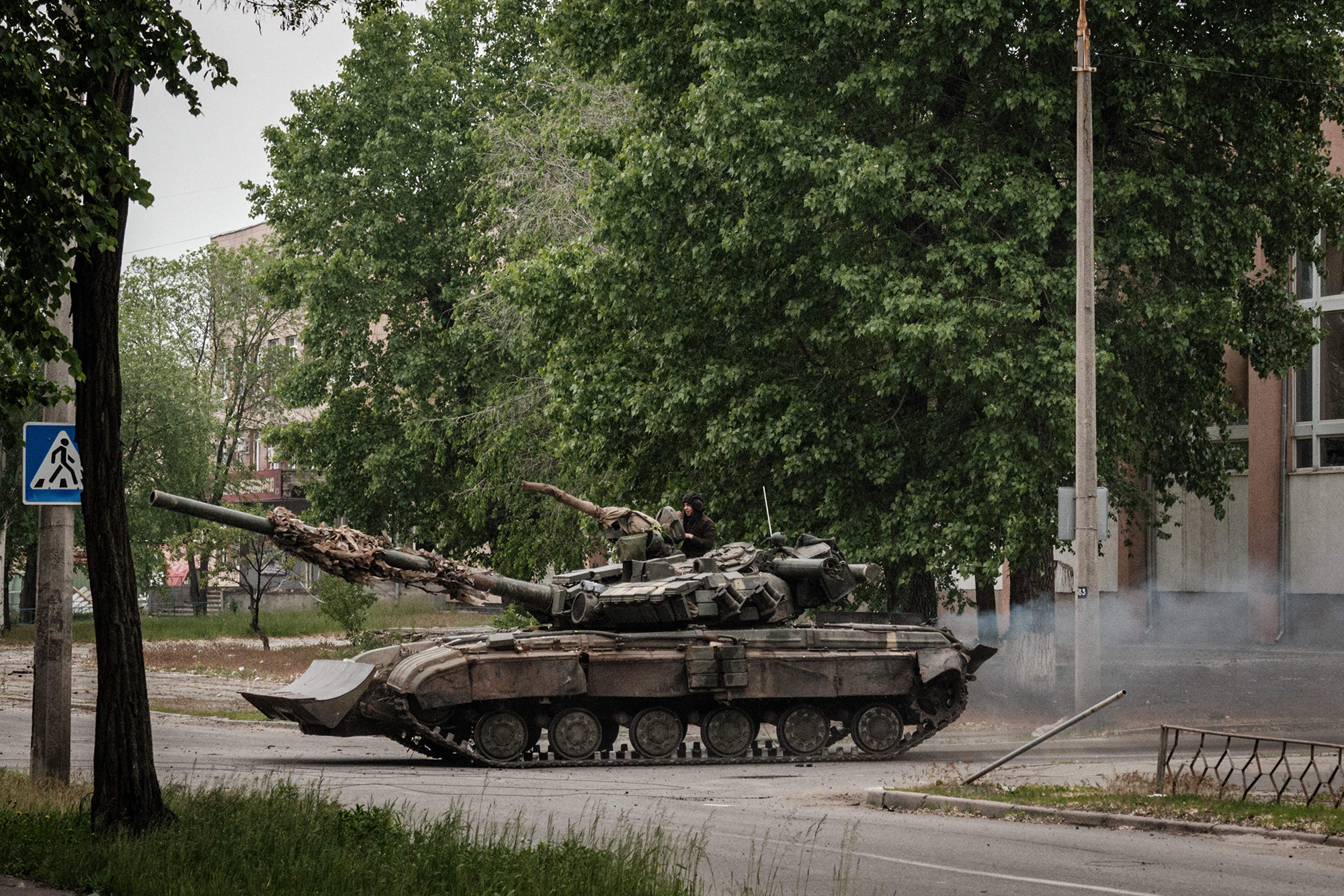 A Ukrainian main battle tank drives on a street during mortar shelling in Severodonetsk, eastern Ukraine, on May 18.
