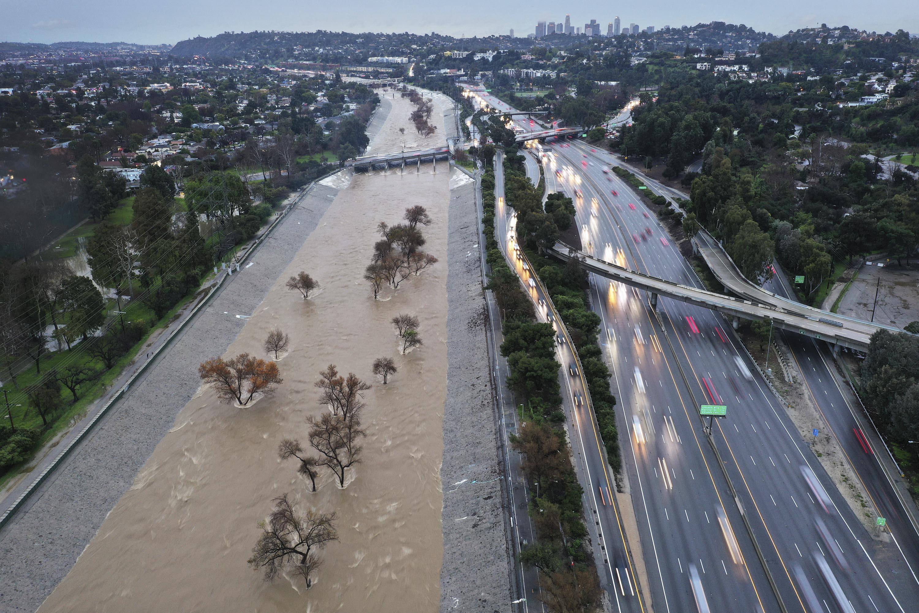 An aerial view shows the Los Angeles River swollen by storm runoff in Los Angeles, California, on February 5. 