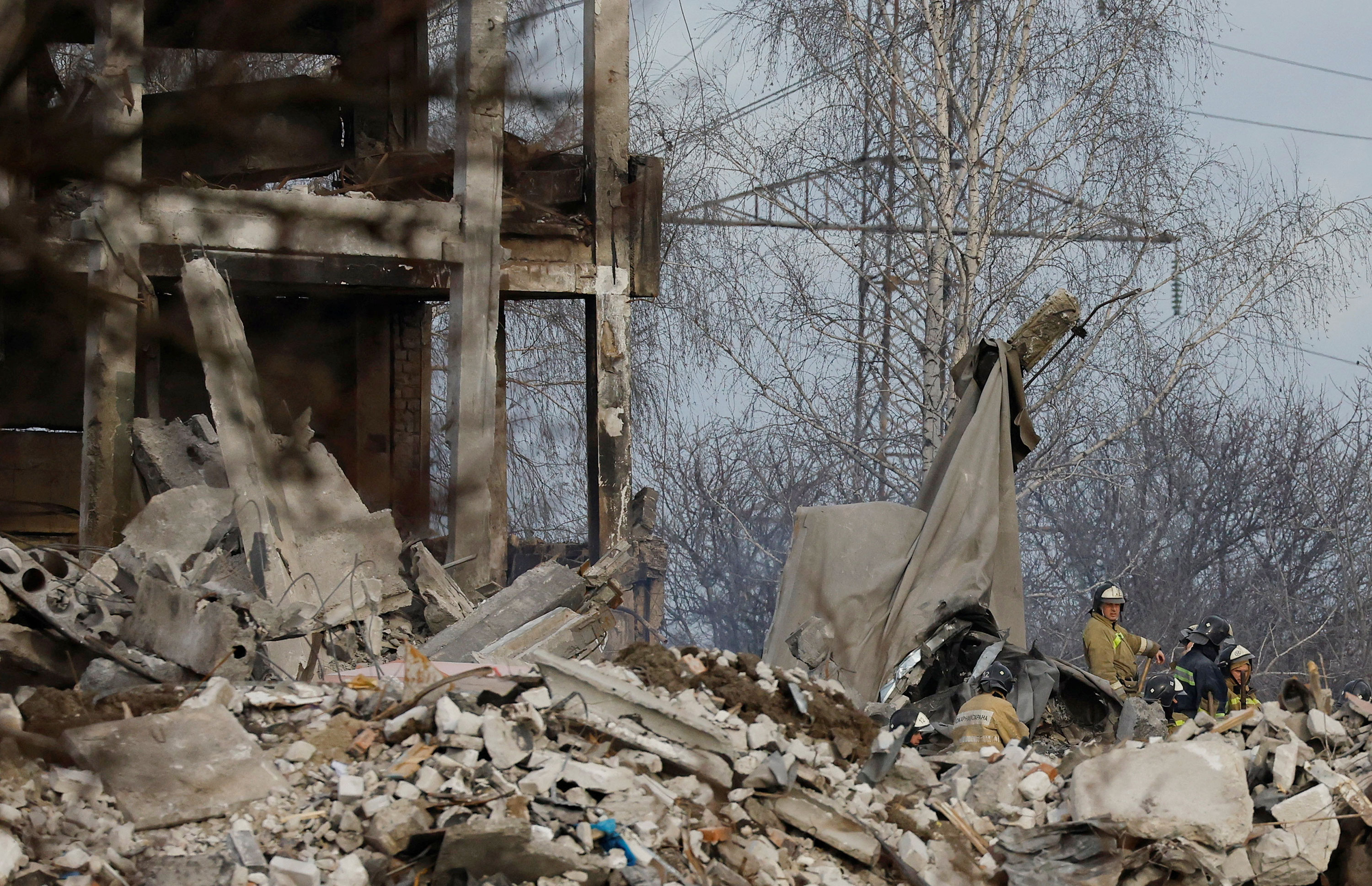 Workers remove debris of a destroyed building purported to be a vocational college used as temporary accommodation for Russian soldiers in Makiivka, Russian-controlled Ukraine on Wednesday.