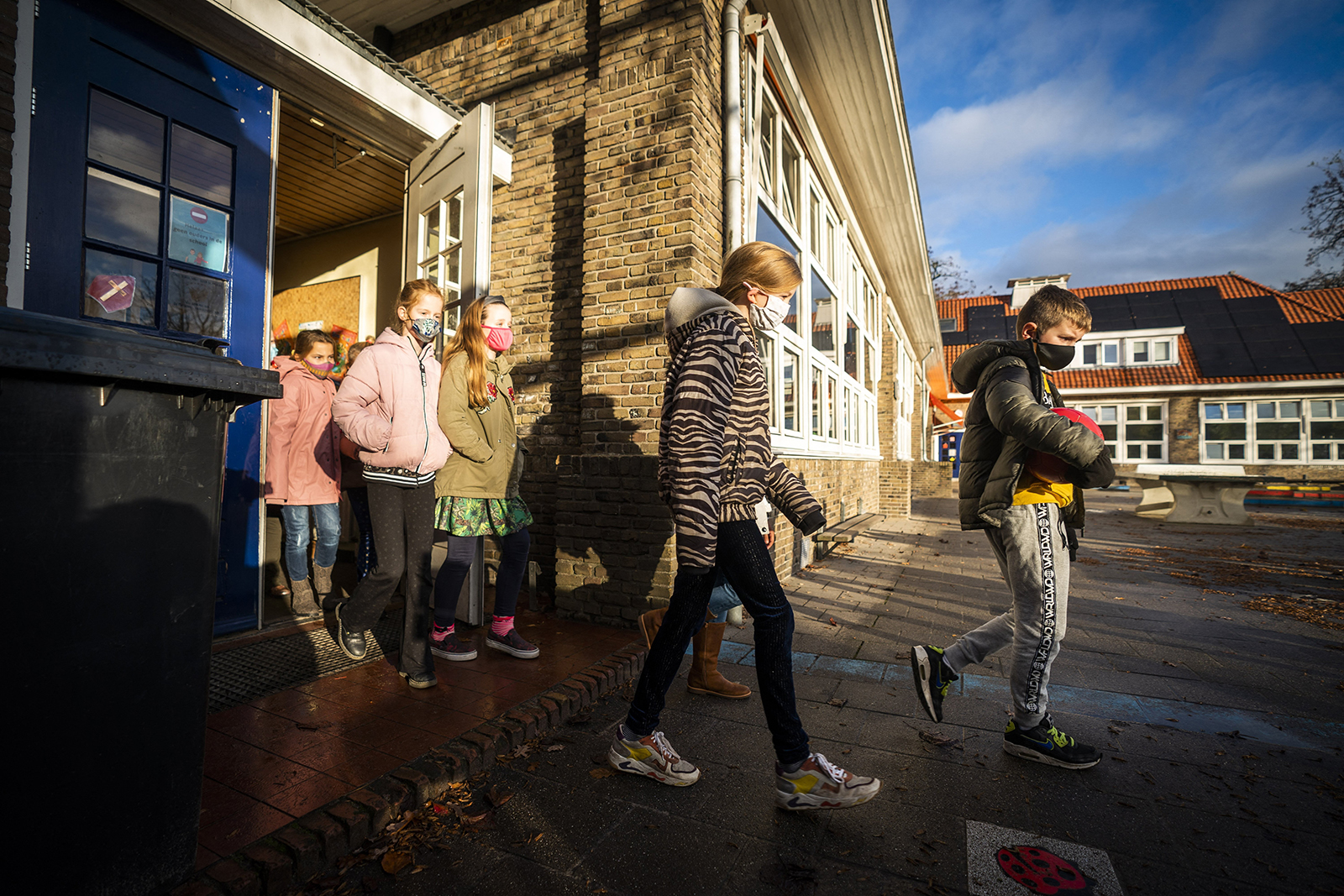 Pupils wearing face masks leave a primary school in de Bilt, on November 29, 2021.