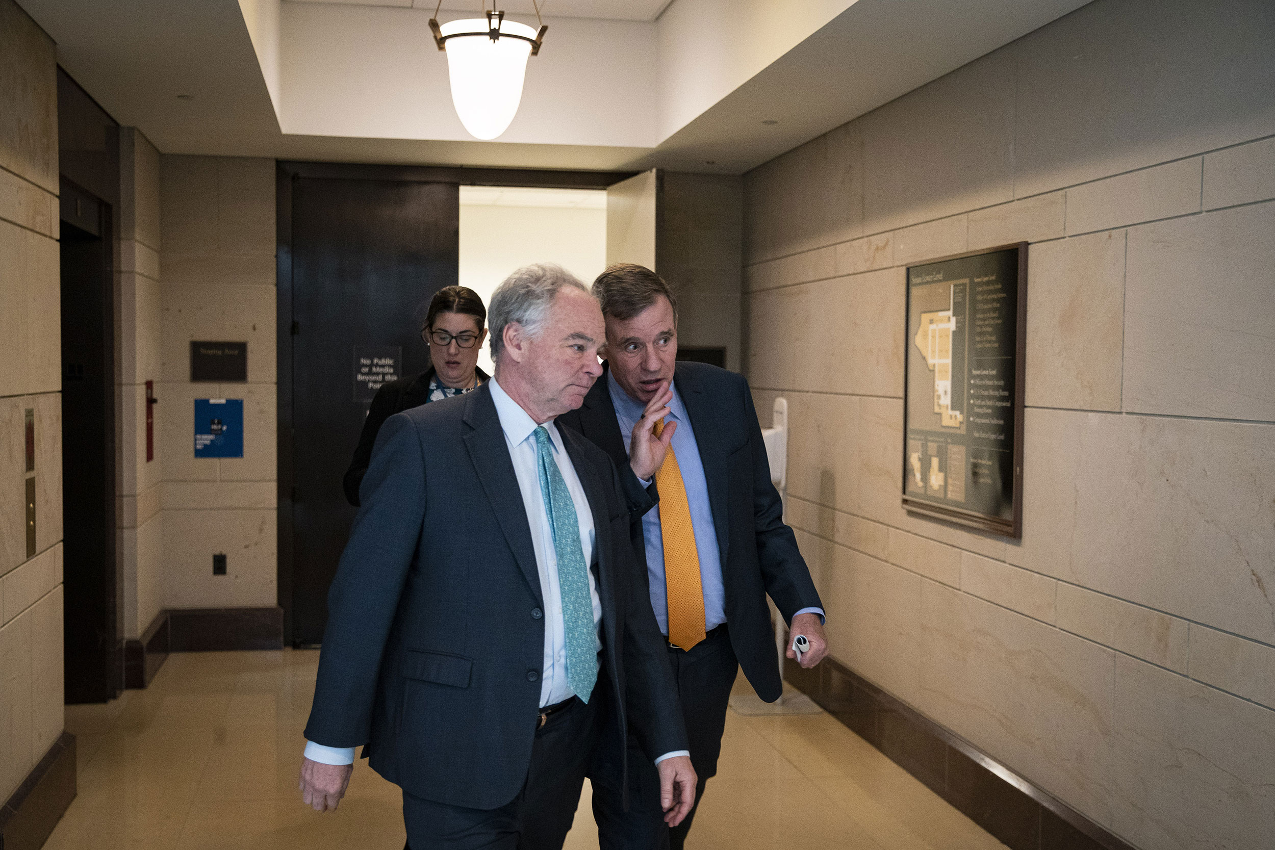 Sens. Tim Kaine, left, and Mark Warner talk while departing from an intelligence briefing on the Chinese spy balloon on February 9.