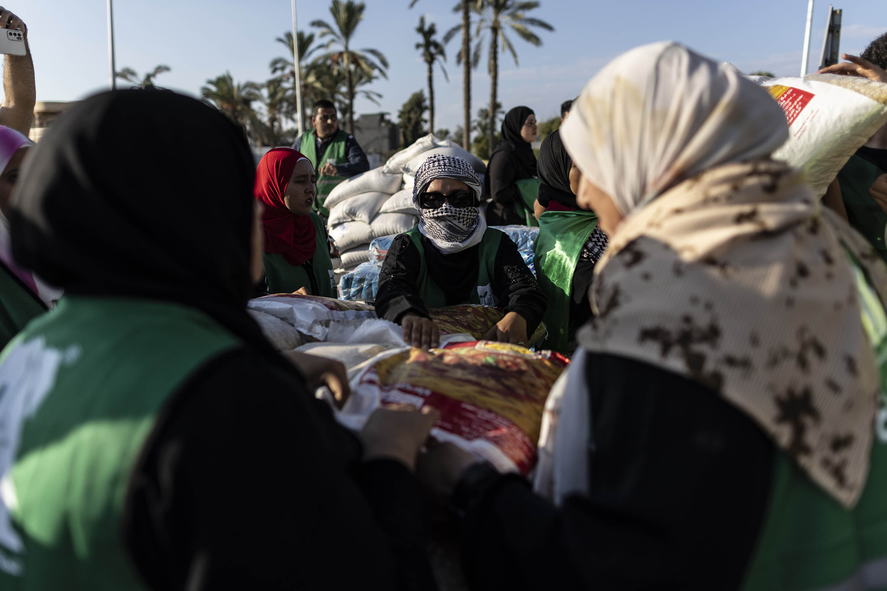 Volunteers load food and supplies onto trucks in an aid convoy for Gaza on October 16, in North Sinai, Egypt. 