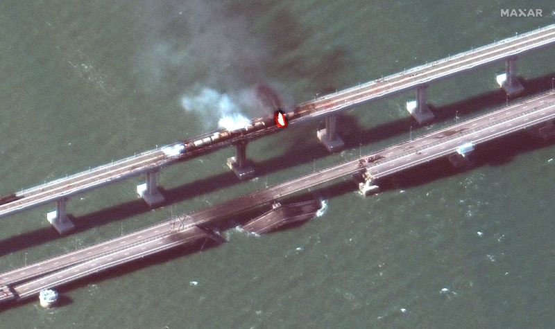 A close up view of damaged bridge and rail cars on fire Crimea bridge.