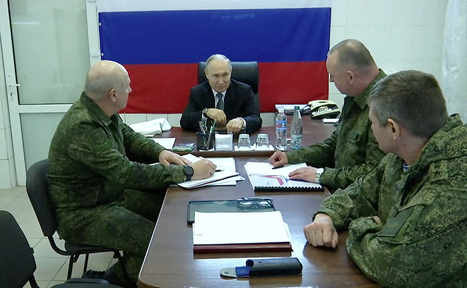 Russian President Vladimir Putin, center, visits the headquarters of the "Dnieper" army group in the Kherson Region in this still image taken from handout video released on April 18, 2023. 