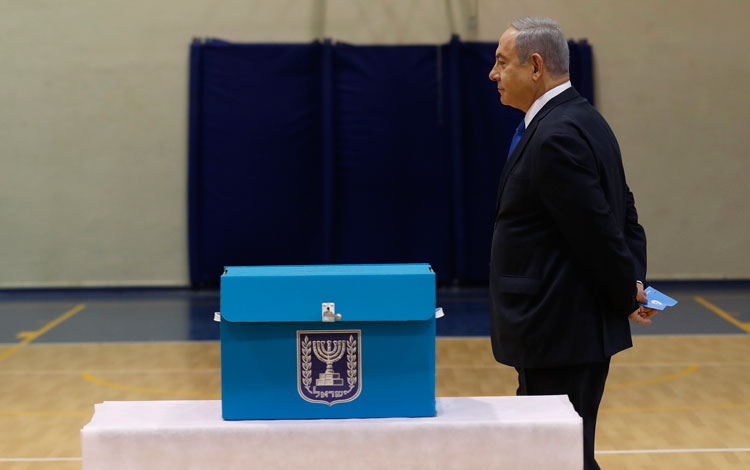 Israeli Prime Minister Benjamin Netanyahu prepares to cast his ballot during the Israeli legislative elections at a polling station in Jerusalem.